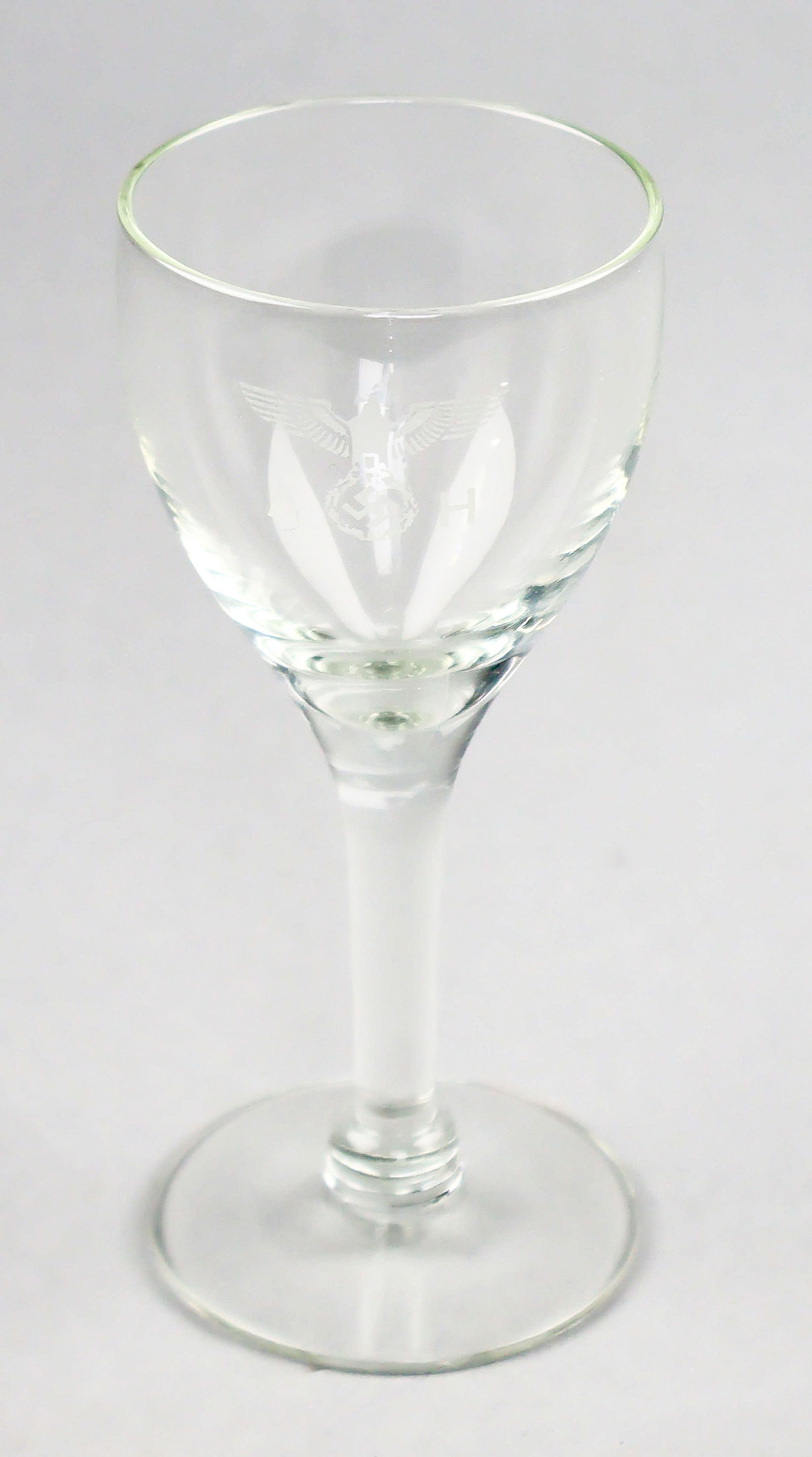 ADOLF HITLER SCHNAPPS GLASS: A great World War II relic, a small schnapps glass once owned by Adolf Hitler, 5 x 2.5 in. dia., bearing Hitler's seal - a national eagle surrounded by the engraved initials 'A H' - to one side, in a