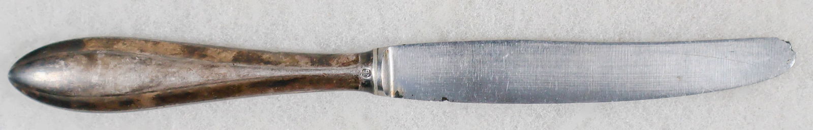 ADOLF HITLER DESSERT KNIFE: Rare dessert knife from the rare set of silverplated tableware used early in Hitler's residence at his Prinzregentenplatz 16, Munich apartment. The 7.25 in. knife bears a very simple handle stamped '9