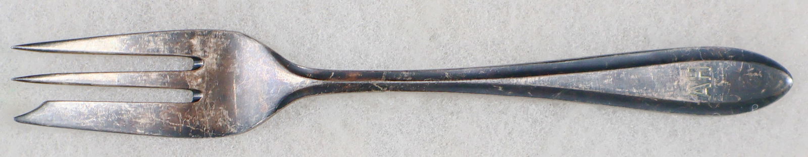 ADOLF HITLER DESSERT FORK: Rare dessert fork from the rare set of silverplated tableware used early in Hitler's residence at his Prinzregentenplatz 16, Munich apartment. The 7.25 in. fork bears a very simple handle stamped '90'