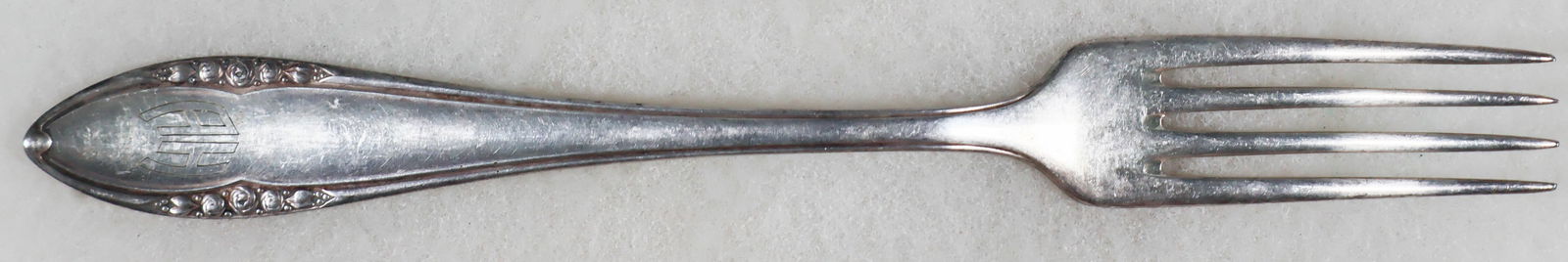 ADOLF HITLER INFORMAL DINNER FORK: An informal silver dinner fork owned and used by Adolf Hitler at non-official, private functions. The four tine fork measures 8.5 in. long and bears his 'A H' 'Berghof pattern' engraved initials at th