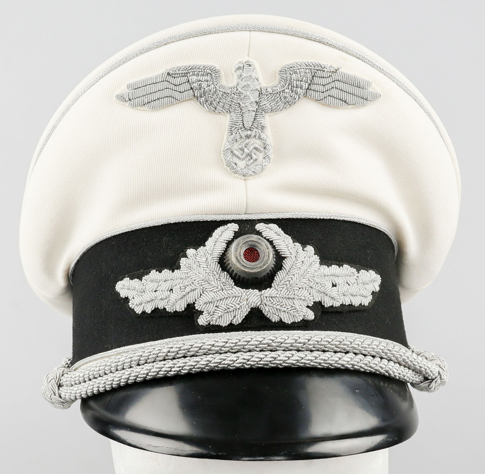 KARL GEORG PFLEIDERER’S SUMMER DIPLOMATIC VISOR CAP: A very rare style of Third Reich headgear, a Diplomatic Officer’s white summer visor cap identified to career German diplomat and politician KARL GEORG PFLEIDERER (1899-1957). The cap is finely