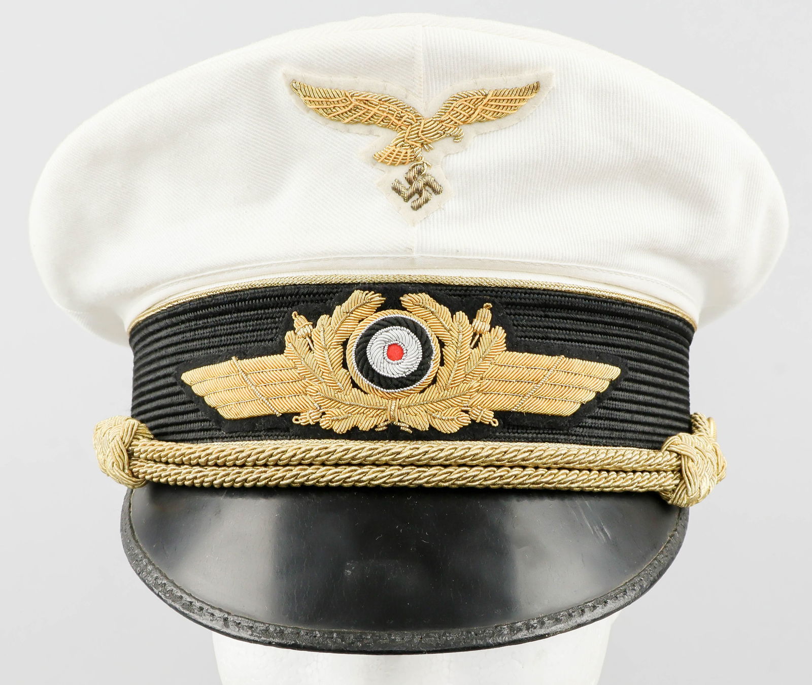 MAXIMILIAN RITTER VON POHL’S LUFTWAFFE GENERAL OFFICER’S SUMMER VISOR CAP: An extremely attractive Luftwaffe General Officer’s white summer visor cap, named to General der Flieger MAXIMILIAN RITTER VON POHL (1893-1951), a recipient of the Knight’s Cross of the Ir