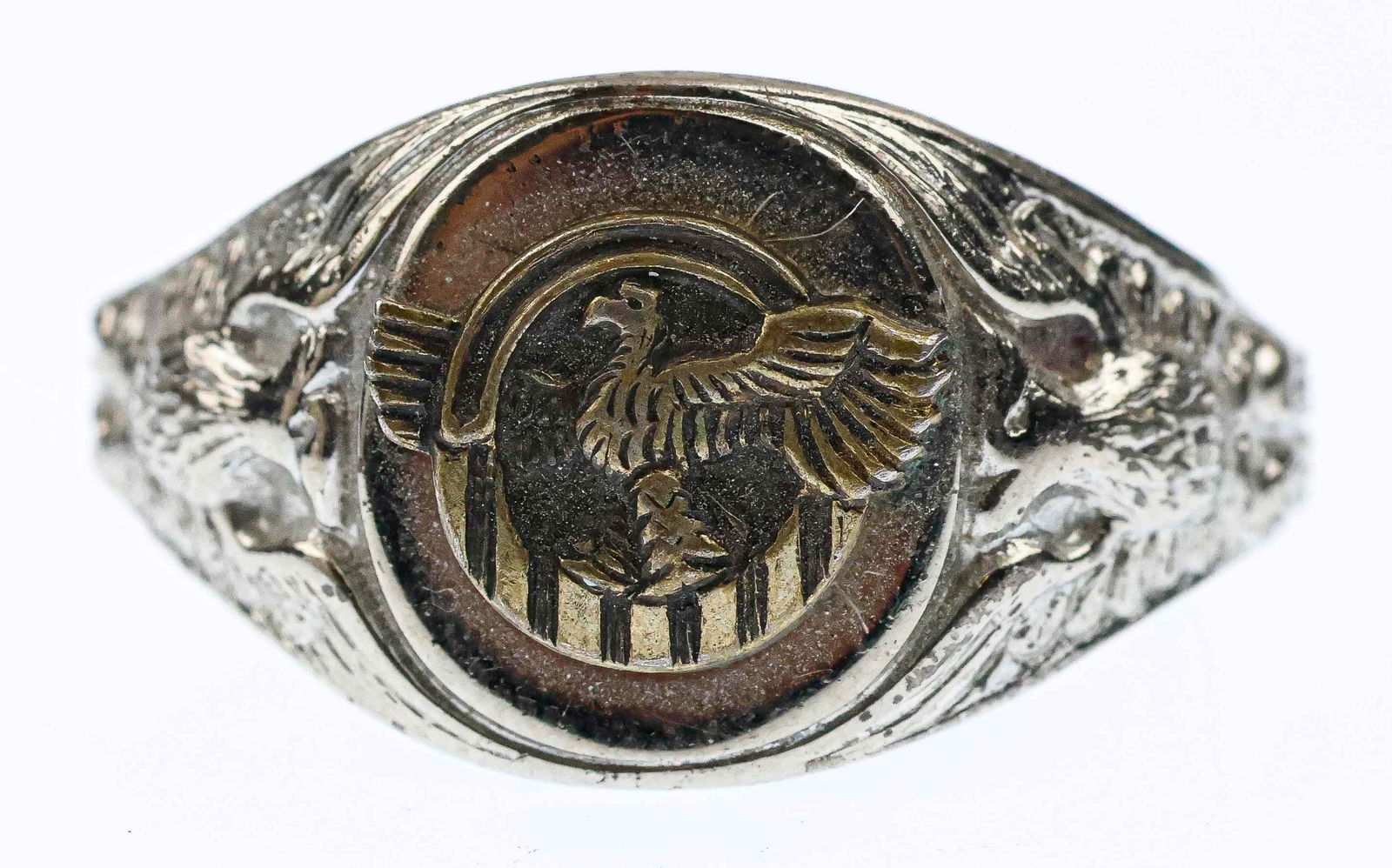 ‘RUPTURED DUCK’ RING: A postwar American sterling silver signet-style ring in sterling silver, bearing the emblem a ‘Ruptured Duck’ in bronze or brass at the middle. This insignia was awarded for honorable