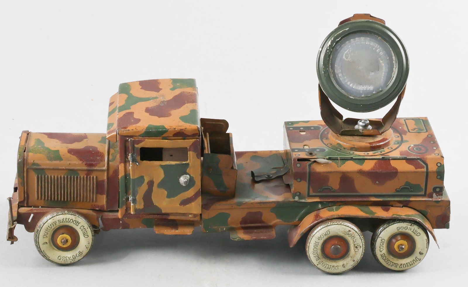 GERMAN TOY SEARCHLIGHT TRUCK: German toy searchlight truck, ca. 1930s, a Tippco 'Schweinwerferauto' made of painted sheet tin with operating driver's door, turning front wheels, and swiveling and tilting searchlight (needs