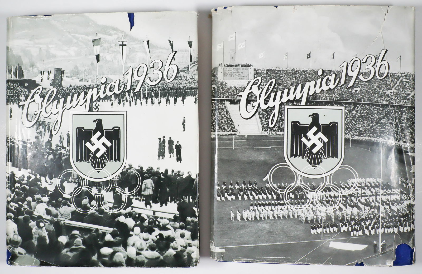 1936 OLYMPICS CIGARETTE CARD BOOKS: A scarce pair of German cigarette card books, both titled 'Olympia 1936', one book created for the 1936 Summer Olympics in Berlin, the other for the 1936 Winter Olympics in Garmisch. Both books were i