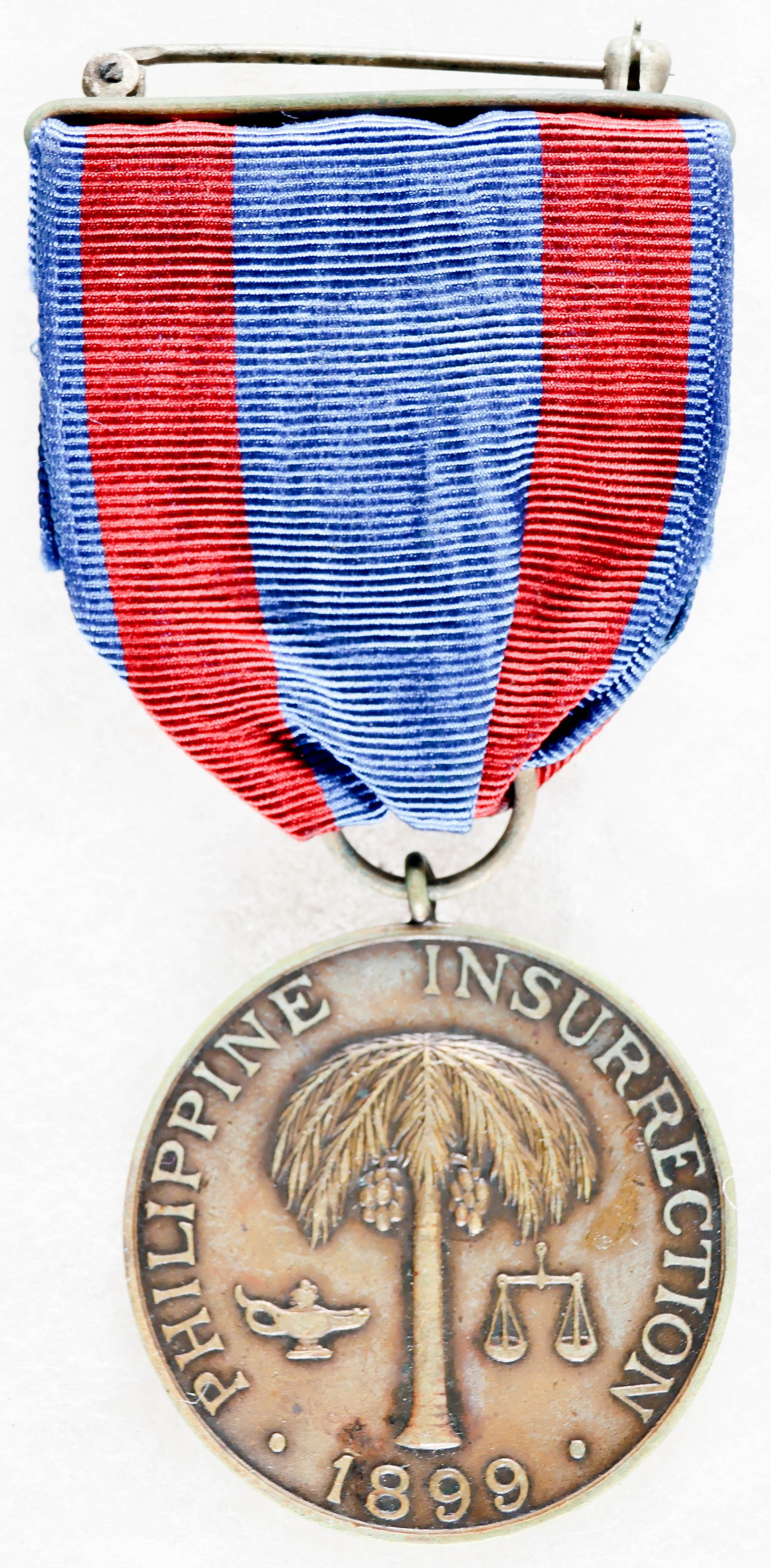 BLACK 25TH INFANTRY SOLDIER’S PHILIPPINE CAMPAIGN MEDAL: A fine, identified example of a U.S. Army Philippine Campaign Medal, awarded to soldiers who took part in the Philippine Insurrection between 1899 and 1913. The obverse of the medal depicts a palm