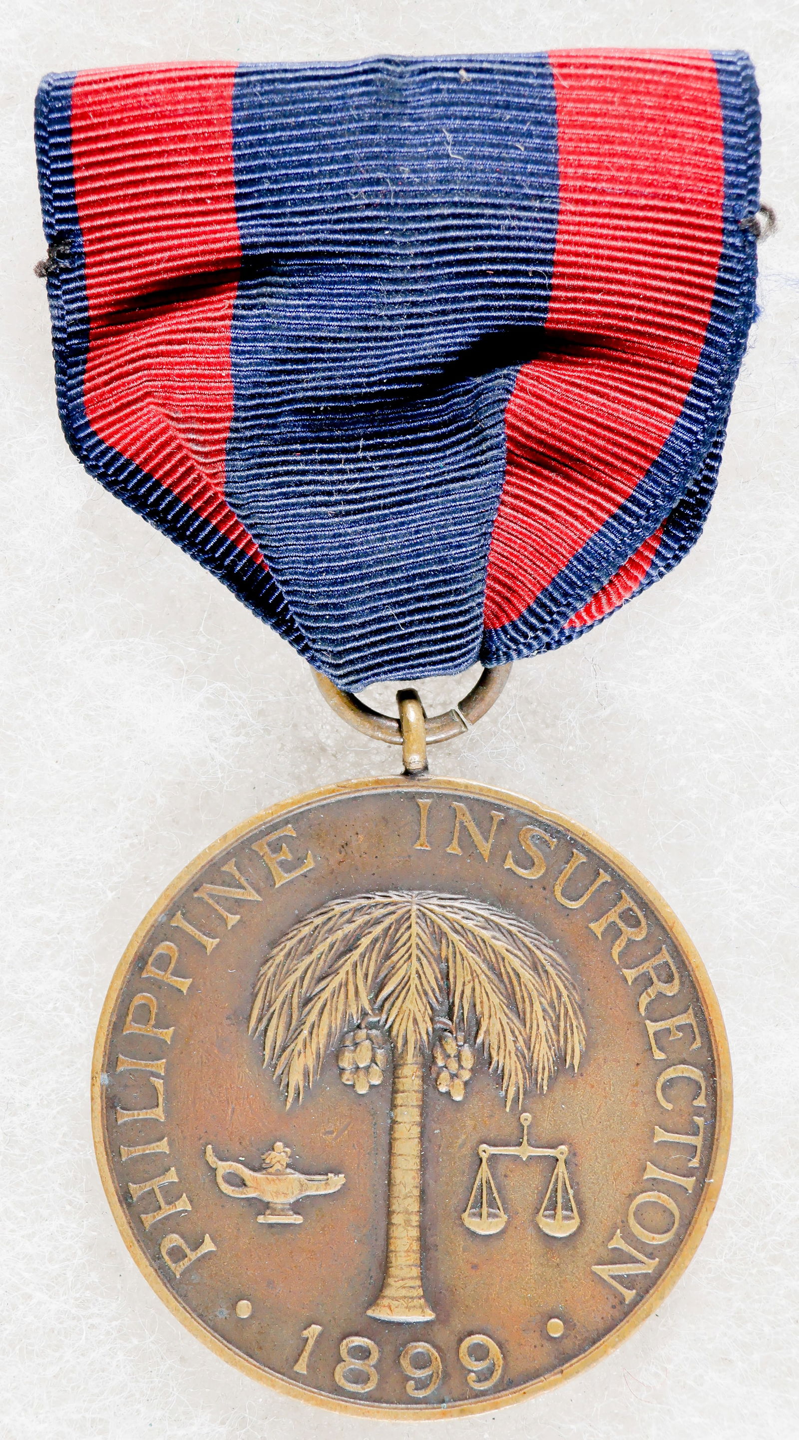 BLACK 10TH CAVALRY SOLDIER’S PHILIPPINE CAMPAIGN MEDAL: A fine, identified example of a U.S. Army Philippine Campaign Medal, awarded who took part in the Philippine Insurrection between 1899 and 1913. The obverse of the medal depicts a palm tree flanked