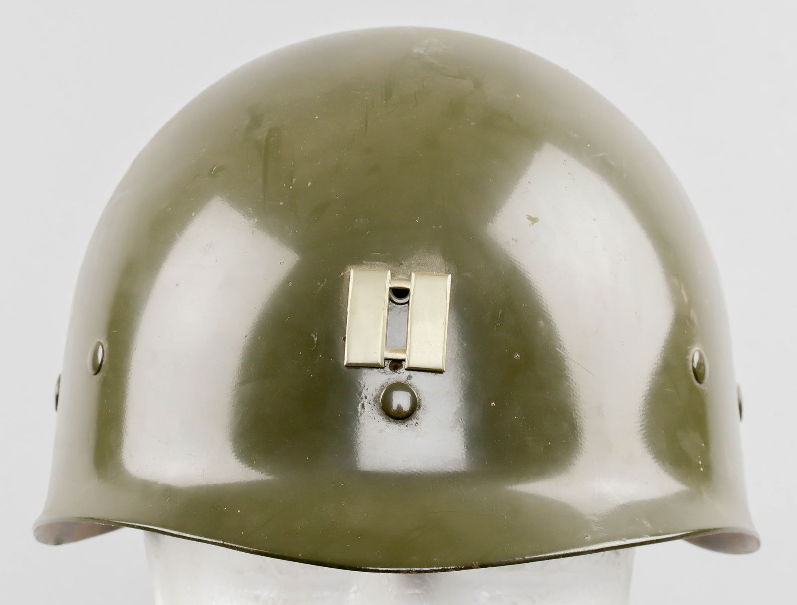 IDENTIFIED 68TH ARMOR REGIMENT CAPTAIN’S M1 HELMET LINER: A U.S. M1 helmet liner, manufactured prior to 1945 by Westinghouse and so marked inside the dome, bearing a captain’s rank bars on the front, with decals depicting the insignia of the 9th
