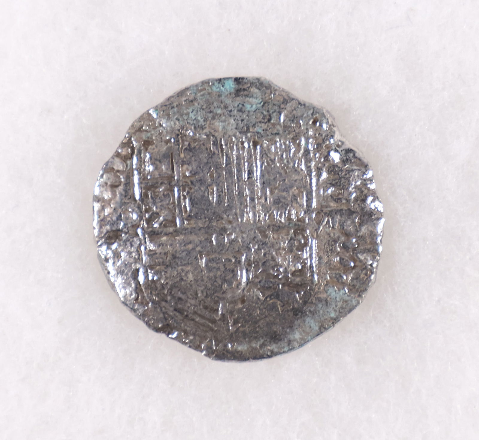 EIGHT REALE SILVER COIN FROM ATOCHA, WITH MEL FISHER CERTIFICATE: Eight reale silver coin, ca. 1598-1621 recovered by salvor Mel Fisher from the wreck of the NUESTRA SENORA DE ATOCHA, a fine strike, with original Treasure Salvors Inc. certificate. Coin number: