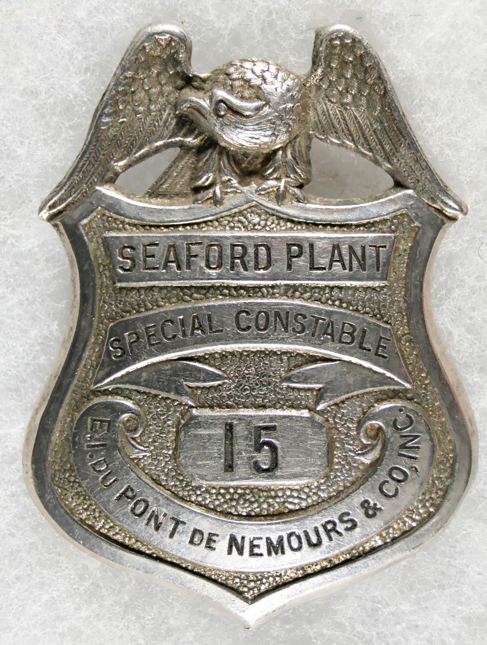 DUPONT SEAFORD PLANT CONSTABLE'S BADGE: Very rare shield-shaped badge, silver plated 2.5 in. tall, displays a spread-winged eagle at top with black-painted inset lettering: 'SEAFORD PLANT' 'SPECIAL CONSTABLE' 'E. I. DU PONT DE NEMOURS &