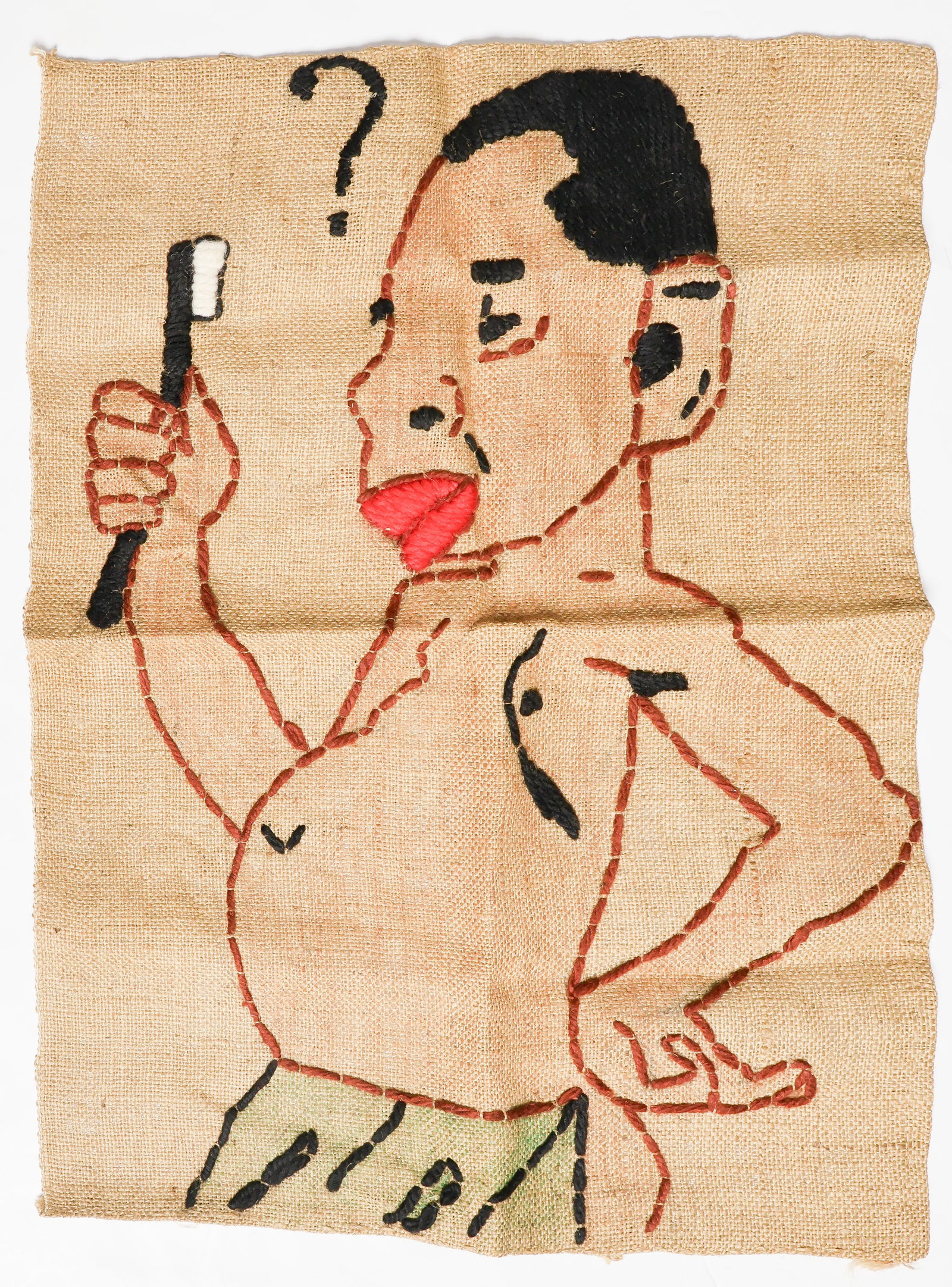 RACIST BURLAP EMBROIDERY: A vintage, offensive depiction of an ‘African’ holding a toothbrush bewilderingly, with a question mark above his head. Crudely embroidered in thick wool yarn on a 23 x 16.5 in. piece of