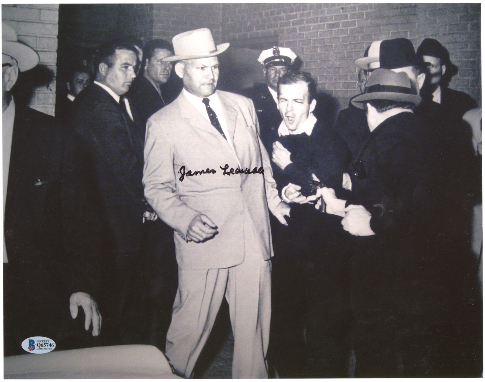 JOHN F. KENNEDY ASSASSINATION (6): Six signed items: an oversize 14 x 11 in. b/w, a reprint of the infamous scene showing Jack Ruby shooting Lee Harvey Oswald, signed by JAMES LEAVELLE (1920-2019) Former Dallas homicide detective who