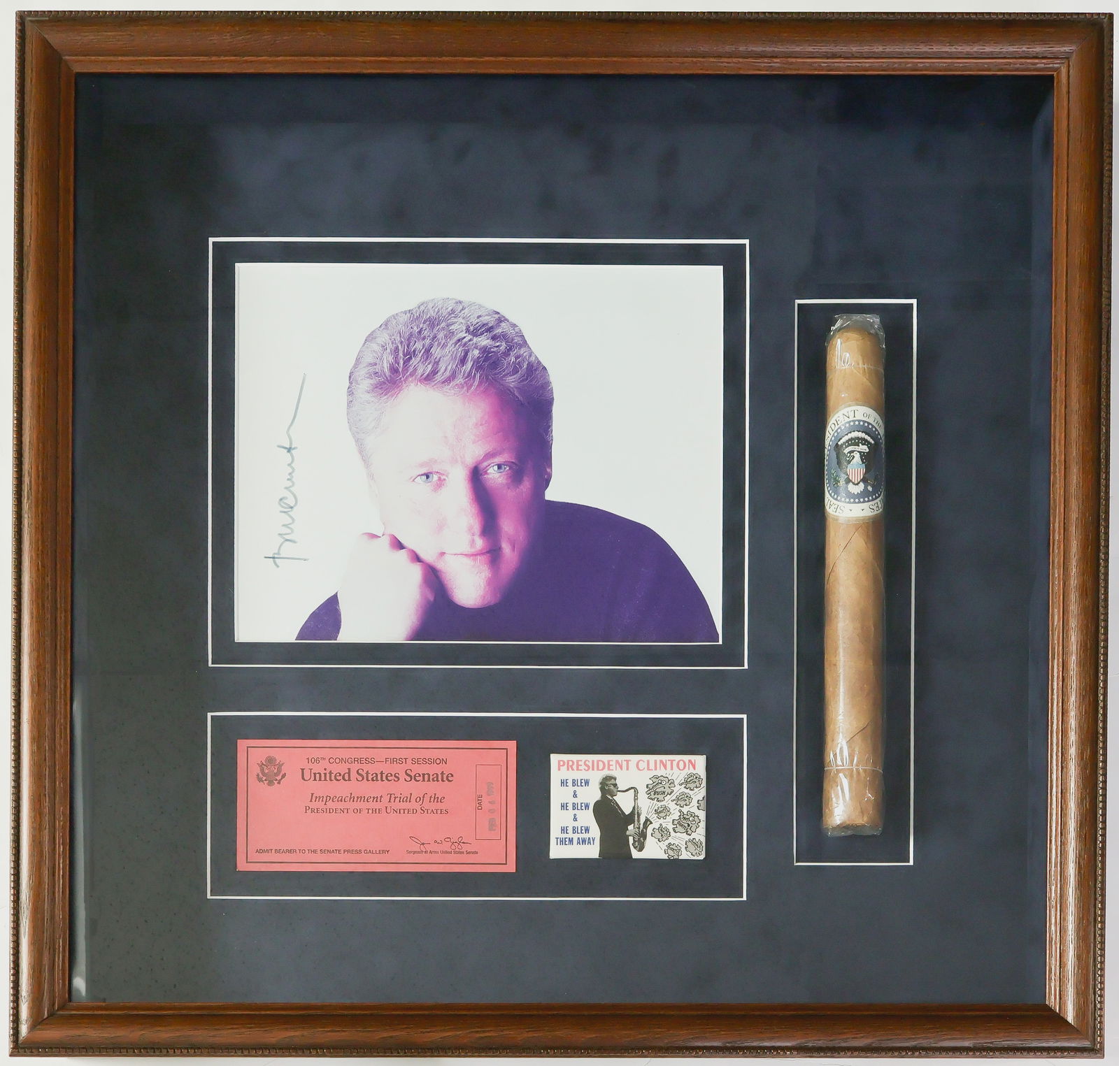 WILLIAM J. CLINTON: (b. 1946) Forty-second President of the United States, the first elected president to be impeached. A collection of items in a wood shadowbox, all gathered by no fan of the ex-president. Included is: