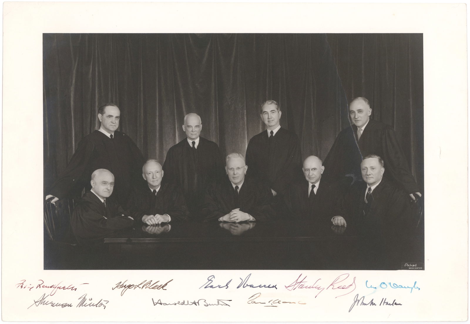 1955 EARL WARREN U.S. SUPREME COURT: Very desirable signed formal photograph of the entire Earl Warren U.S. Supreme Court, ca. 1955, one of the most influential court in the country's history whose Brown vs. Topeka Board of Education