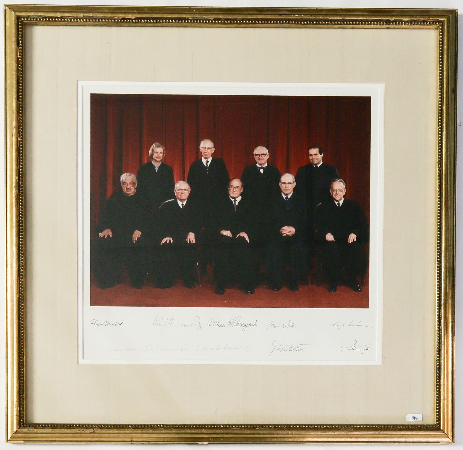 1986 WILLIAM H. REHNQUIST U.S. SUPREME COURT: Excellent signed formal photograph of the entire William H. Rehnquist U.S. Supreme Court, ca. 1986. The 15 x 14 in. (overall) color image is signed on the mount by the nine members of the court, gener