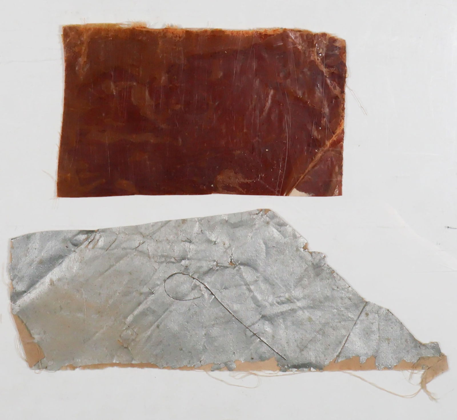 ZEPPELIN HINDENBURG SILVER FABRIC AND GAS BAG CRASH RELICS: Rare relics from the tragic May 6, 1937 crash of the German passenger airship Hindenburg at Lakehurst, New Jersey, several sections of fabric that once made up part of the outer "skin" and inner