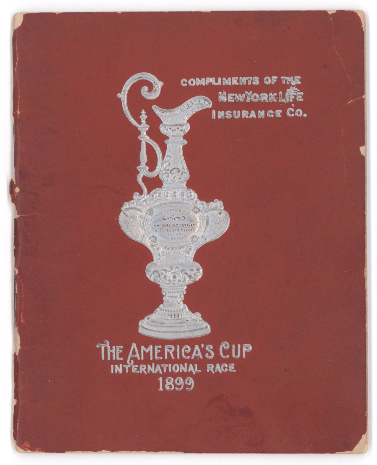 VINTAGE AMERICA'S CUP BOOK: Rare souvenir of the 1899 America's Cup sailing competition, a 4 x 5 in. 32pp. silver embossed booklet setting forth the history of the fiercely-fought competition since 1851 and including an
