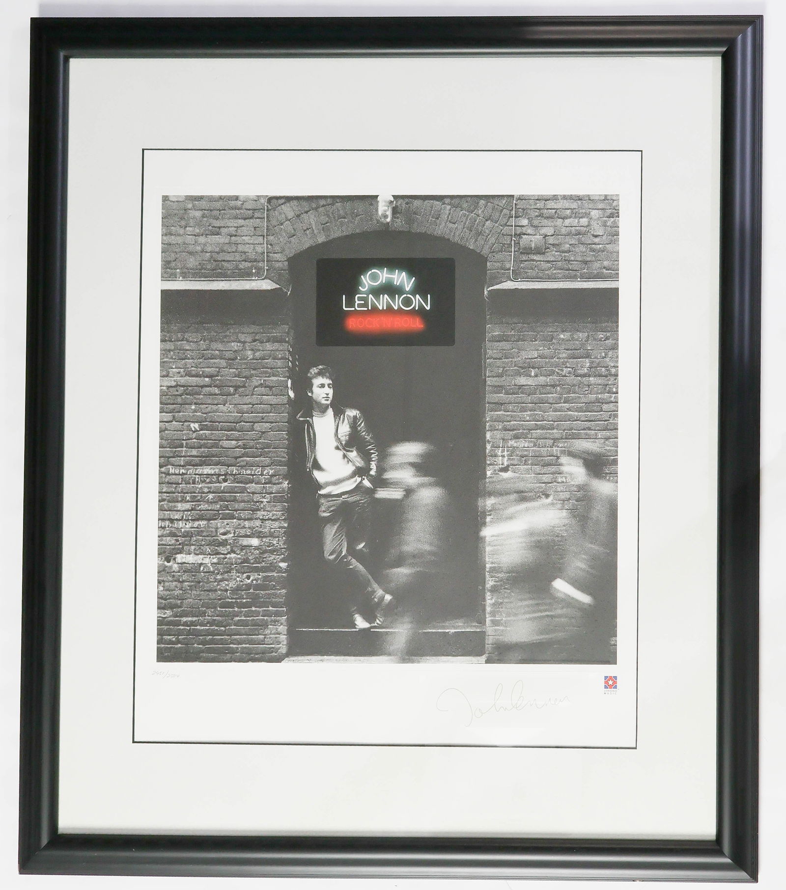 JOHN LENNON ART PRINT: John Lennon Rock 'N' Roll limited edition fine art lithograph print issued by Lenono Music, 1995. A classic Hamburg-era photo of John Lennon standing in a doorway in his leather jacket, used on the