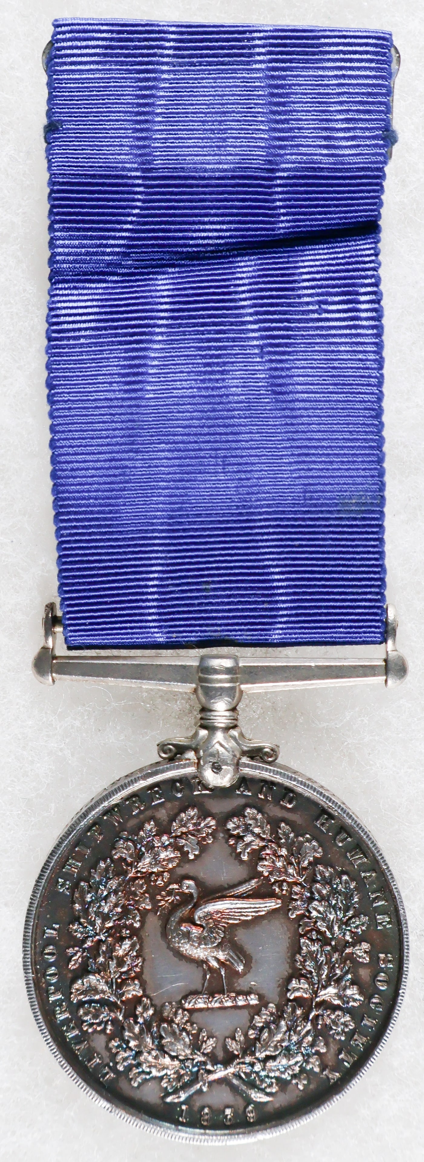 LIVERPOOL SHIPWRECK & HUMANE SOCIETY MARINE MEDAL: Liverpool Shipwreck & Humane Society Marine Medal, third type, obverse showing a man kneeling on a piece of wreckage saving a woman and child from the water; in the distance a boat picking up a