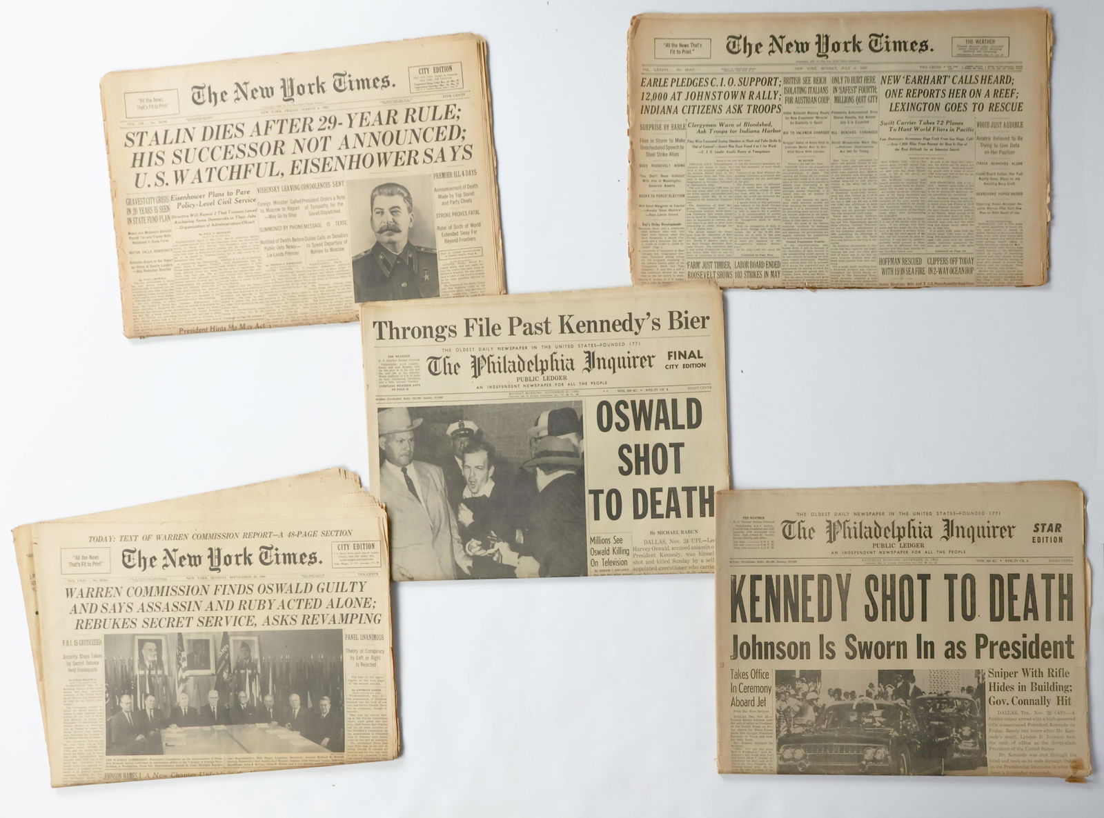 HISTORIC NEWSPAPERS (5): A collection of five newspapers that detail important historic events. Includes: a July 5, 1937 issue of the ‘New York Times’ with the headline ‘NEW ‘EARHART’ CALLS