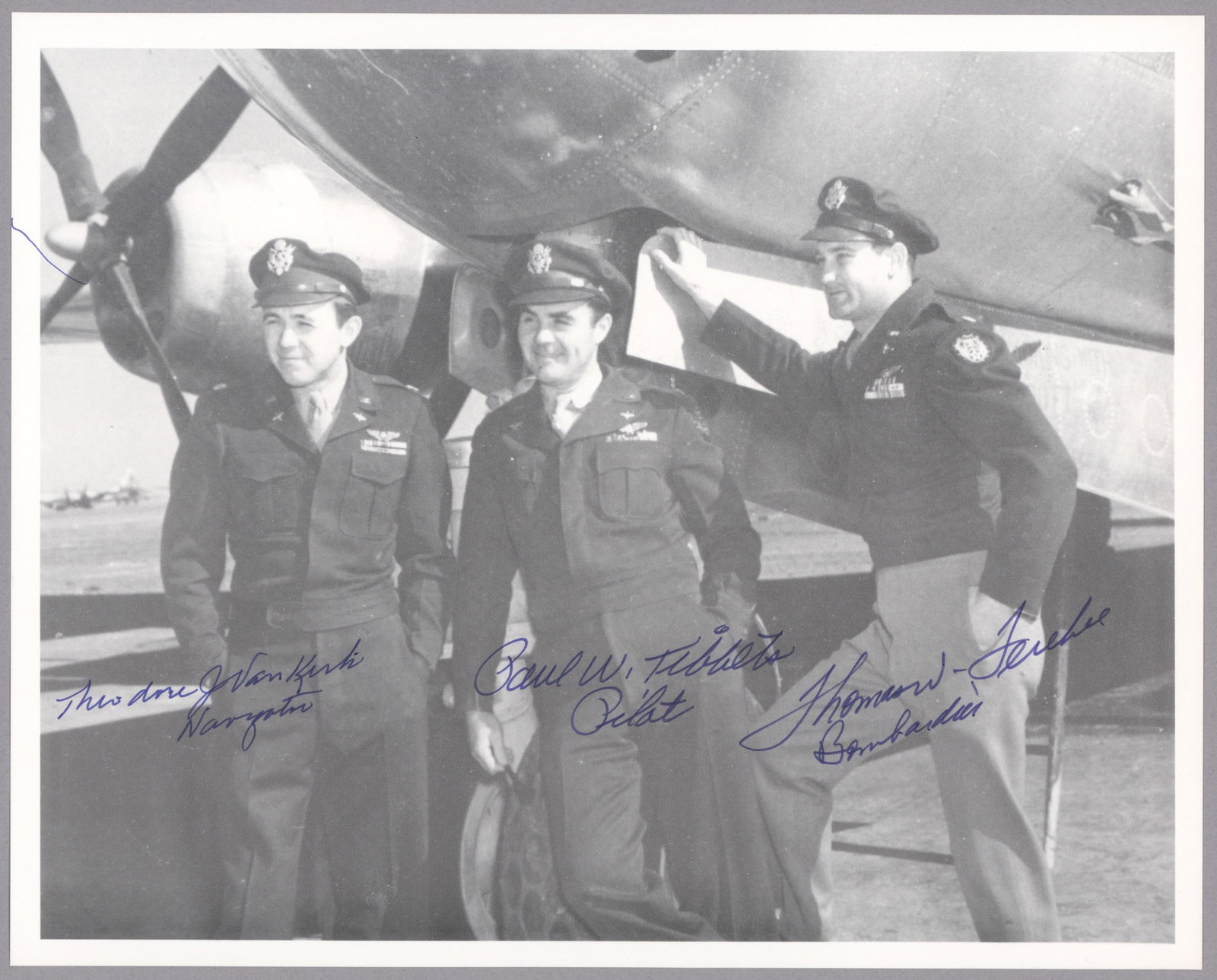 ENOLA GAY CREW-SIGNED PHOTOGRAPH: Excellent S.P., 8 x 10 in. b/w, an image of Enola Gay pilot PAUL TIBBETS (1915-2008), bombardier THOMAS FEREBEE, and navigator DUTCH VAN KIRK (1921-2014), all standing at the nose of the Enola Gay,