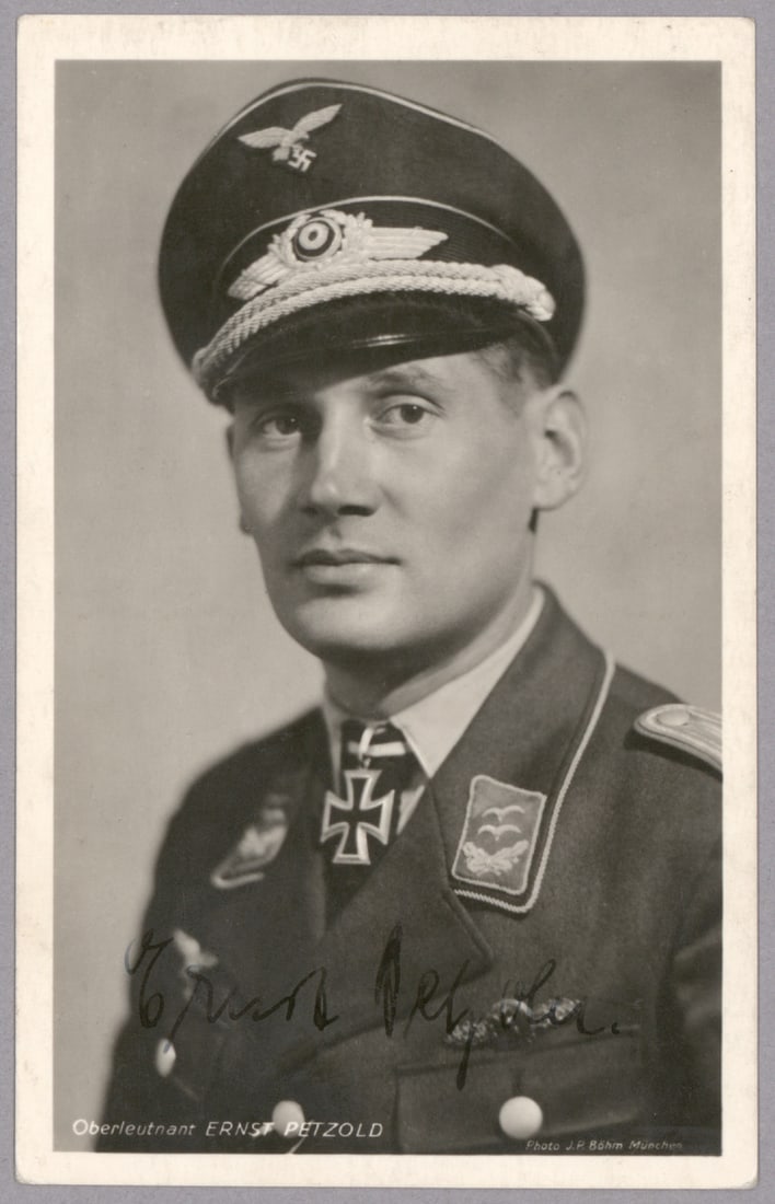 ERNST PETZOLD: (1914-1999) Luftwaffe Totenkopf ace who flew a total of 214 sorties, awarded the Knights Cross of the Iron Cross. Fine vintage S.P. 4 x 6 in. b/w, a Hoffmann real-photo postcard showing Petzold in uni