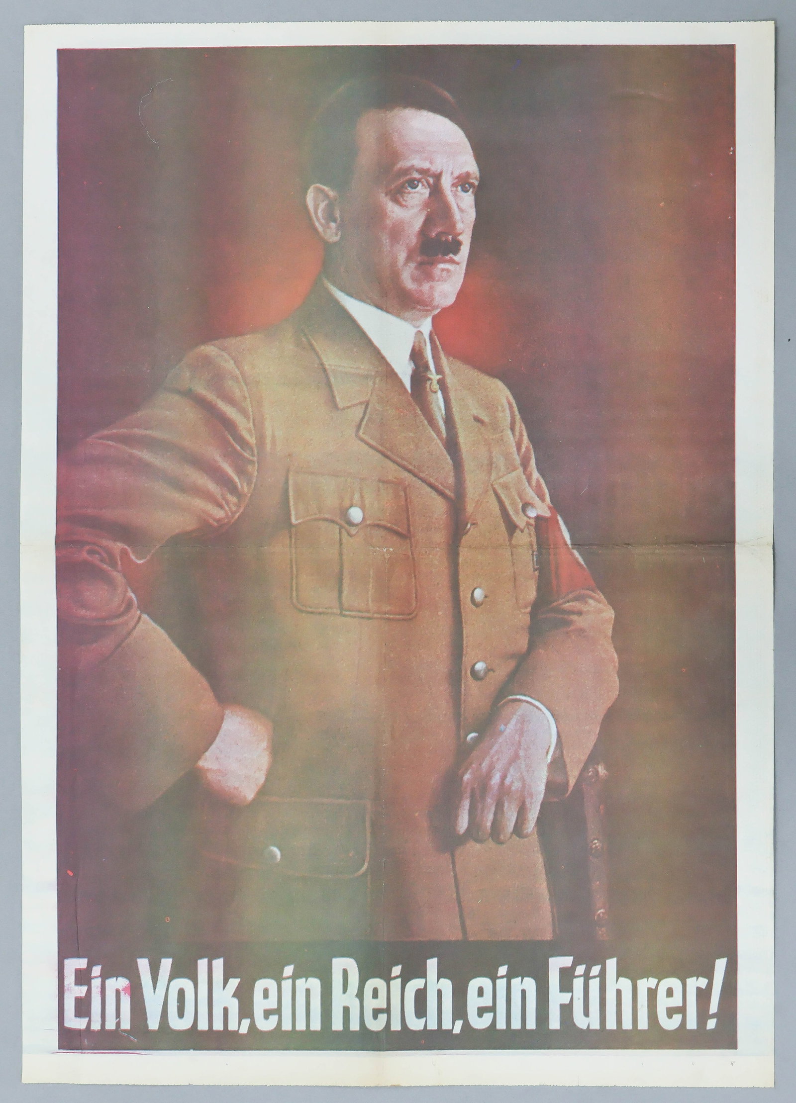 'EIN VOLK, EIN REICH, EIN FUHRER!': A rare full page newspaper insert version of this iconic poster. Perhaps one of the most famous propaganda posters to emanate from Naza Germany, this version, a 16.25 in. x 22.5 in. poster on newspape