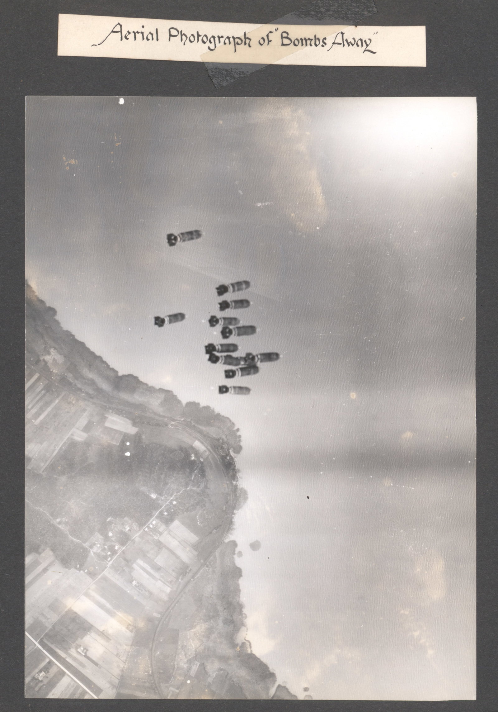 15TH A.A.F. HEADQUARTERS BOMB STRIKE PHOTOGRAPHS: Excellent photograph album, an assemblage of 24 6 x 8 in. b/w mounted photographs taken during and following bombing missions by various elements of the 15th Air Force, based first in Tunisia and