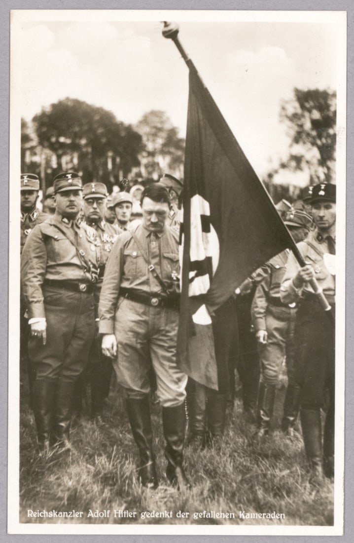 ADOLF HITLER AND ERNST ROHM: Scarce postcard photograph, 3.5 x 5.5 in., a 1923 image showing Adolf Hitler with S.A. leader Ernst Rohm at his side, Hitler clutching the flag carried in the march during the Beer Hall Putsch which