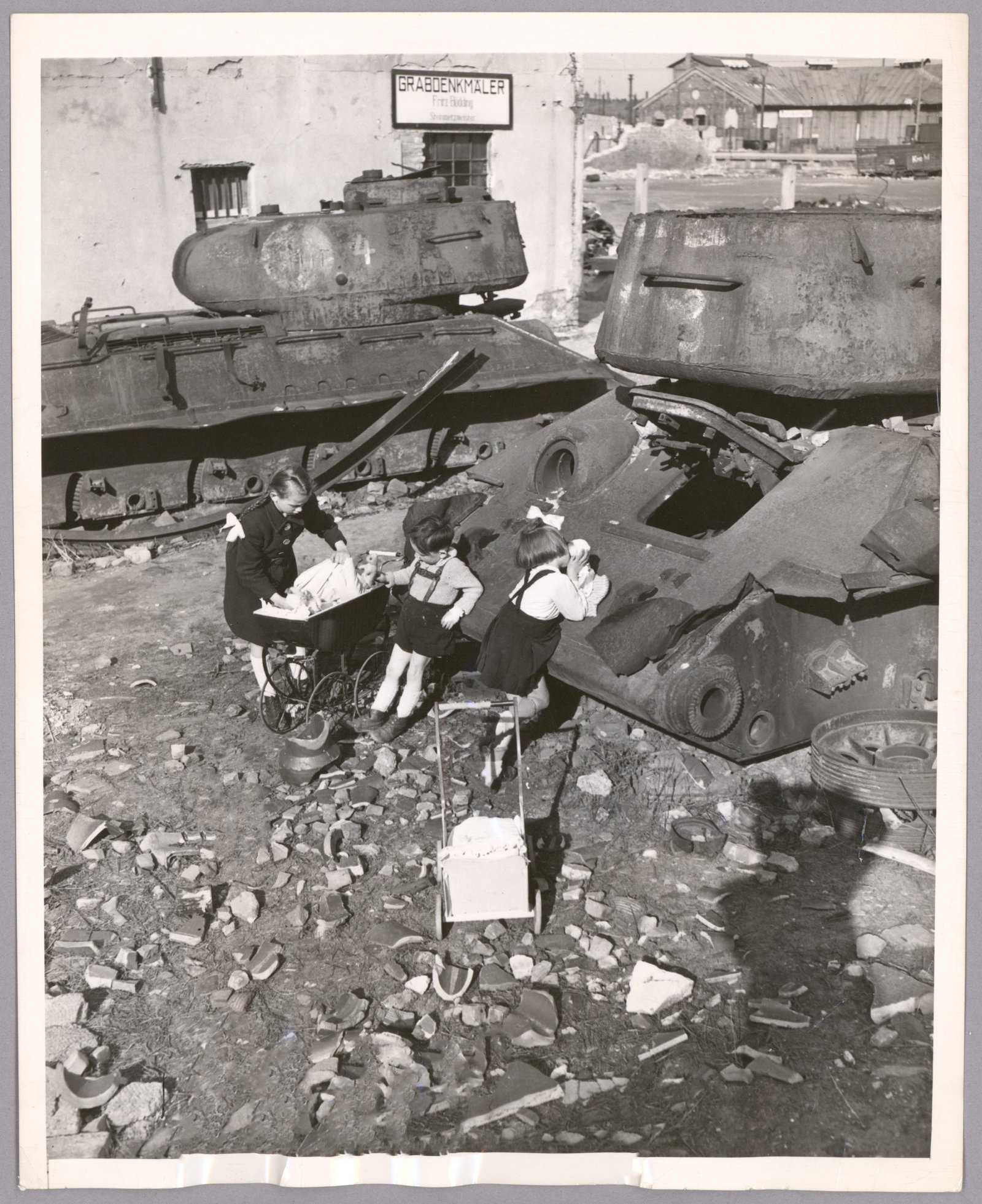 CHILDREN IN THE RUINS OF BERLIN (3): Good lot of three 8 x 10 in. original period press photographs, each with ink press attribution, date stamp and paper caption on verso, the images showing German children in Berlin in 1948 playing