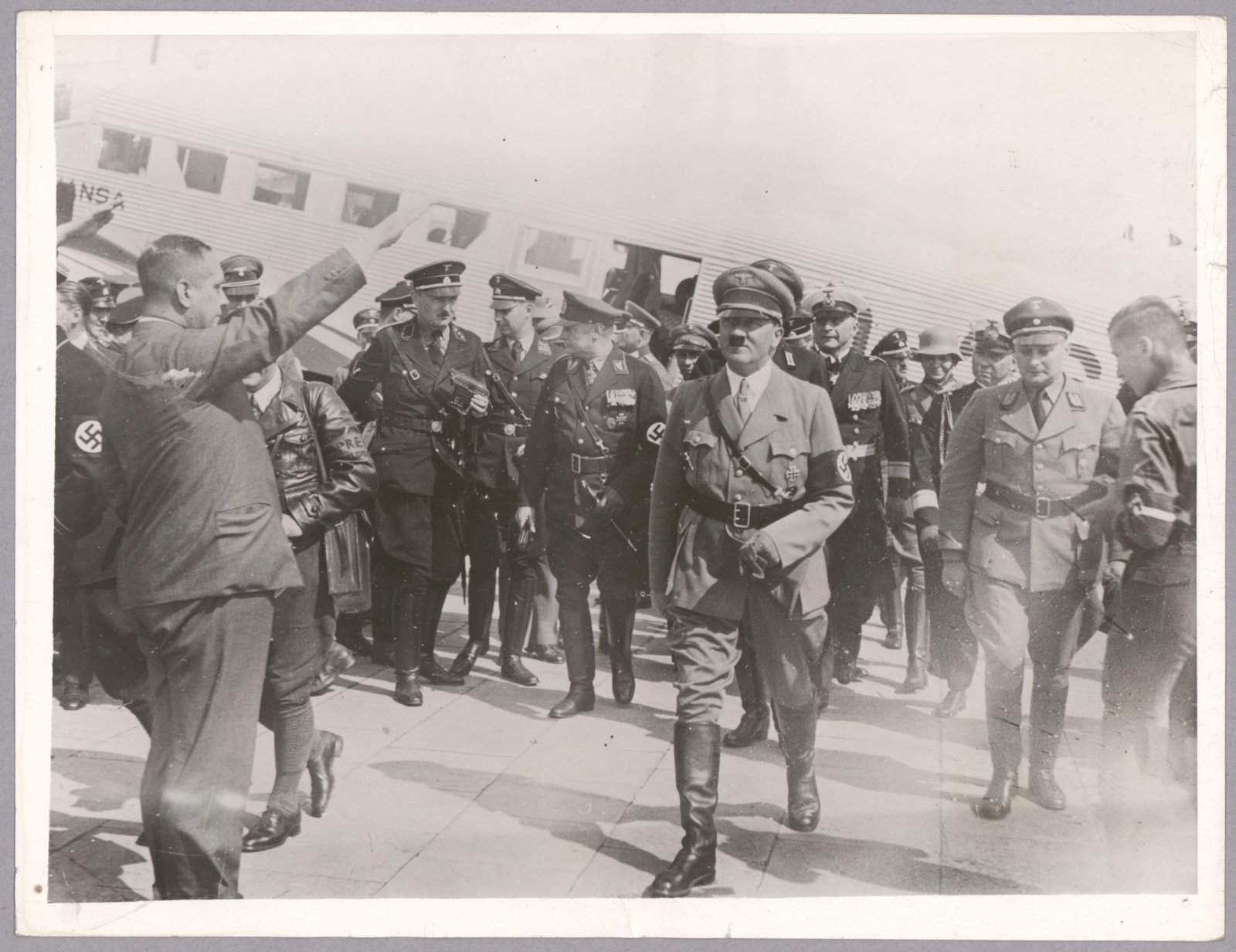 HITLER WITH HIS SS MEN (3): Good lot of three 7 x 9.25 in. original period press photographs, each with ink press attribution, date stamp and paper caption on verso, the images alternately showing Adolf Hitler reviewing