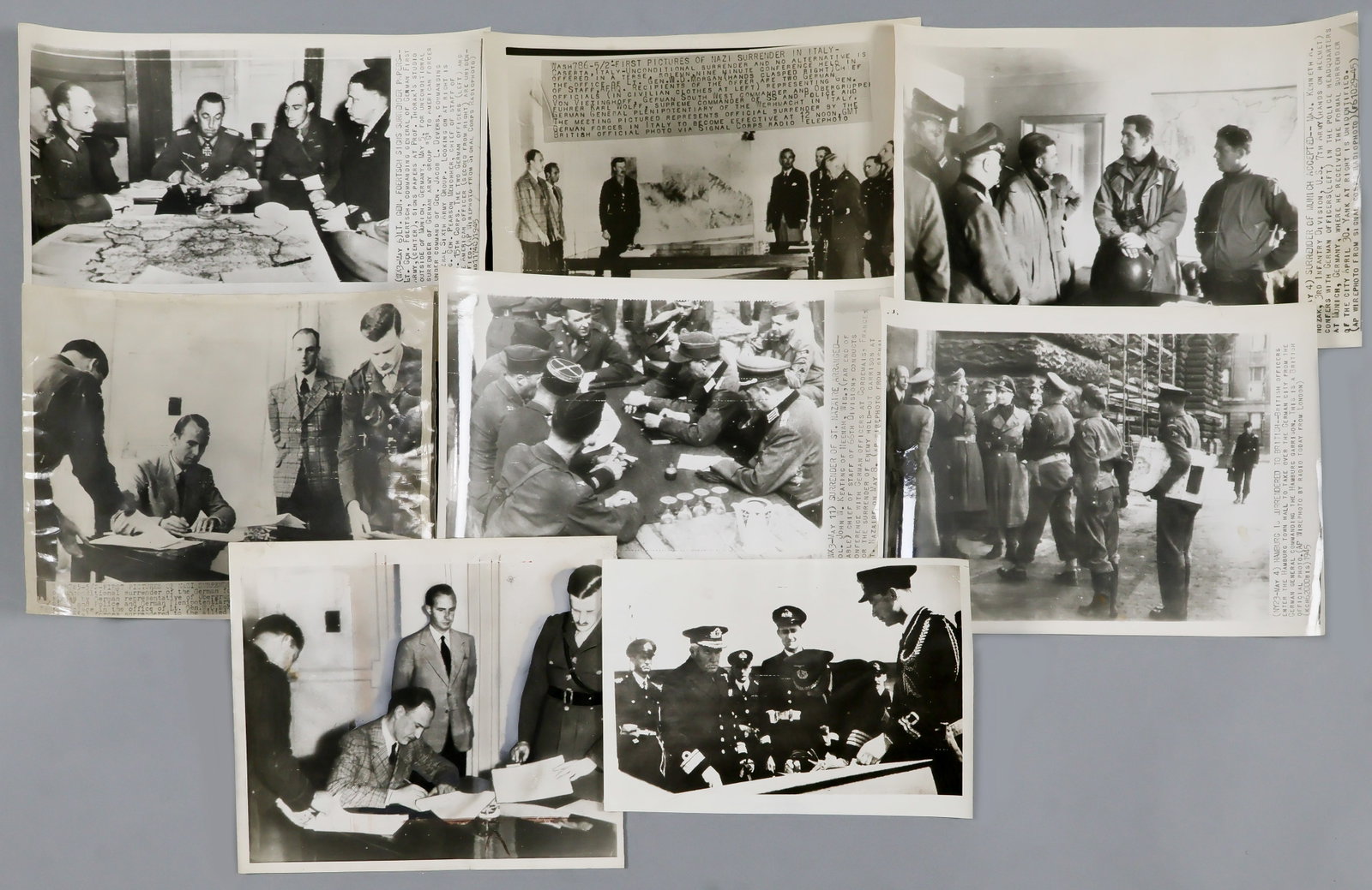 THE GERMANS SURRENDER THEIR CONQUESTS AND CITIES (8): Lot of eight original, period American-issue press photographs, all about 8 x 10 in. or larger, showing ceremonies following the German surrenders of Army Group G, occupied Italy, Munich, St.