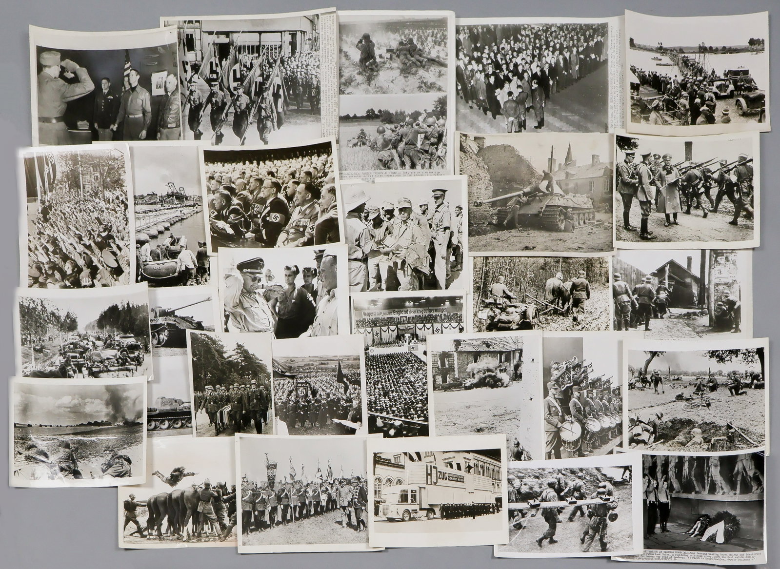 WORLD WAR II MILITARY PHOTOGRAPHS (20): Lot of 20 original and contemporary press photographs, virtually all with stamped press attributions, dates, and printed captions on versos, a large variety of views including German engineers and