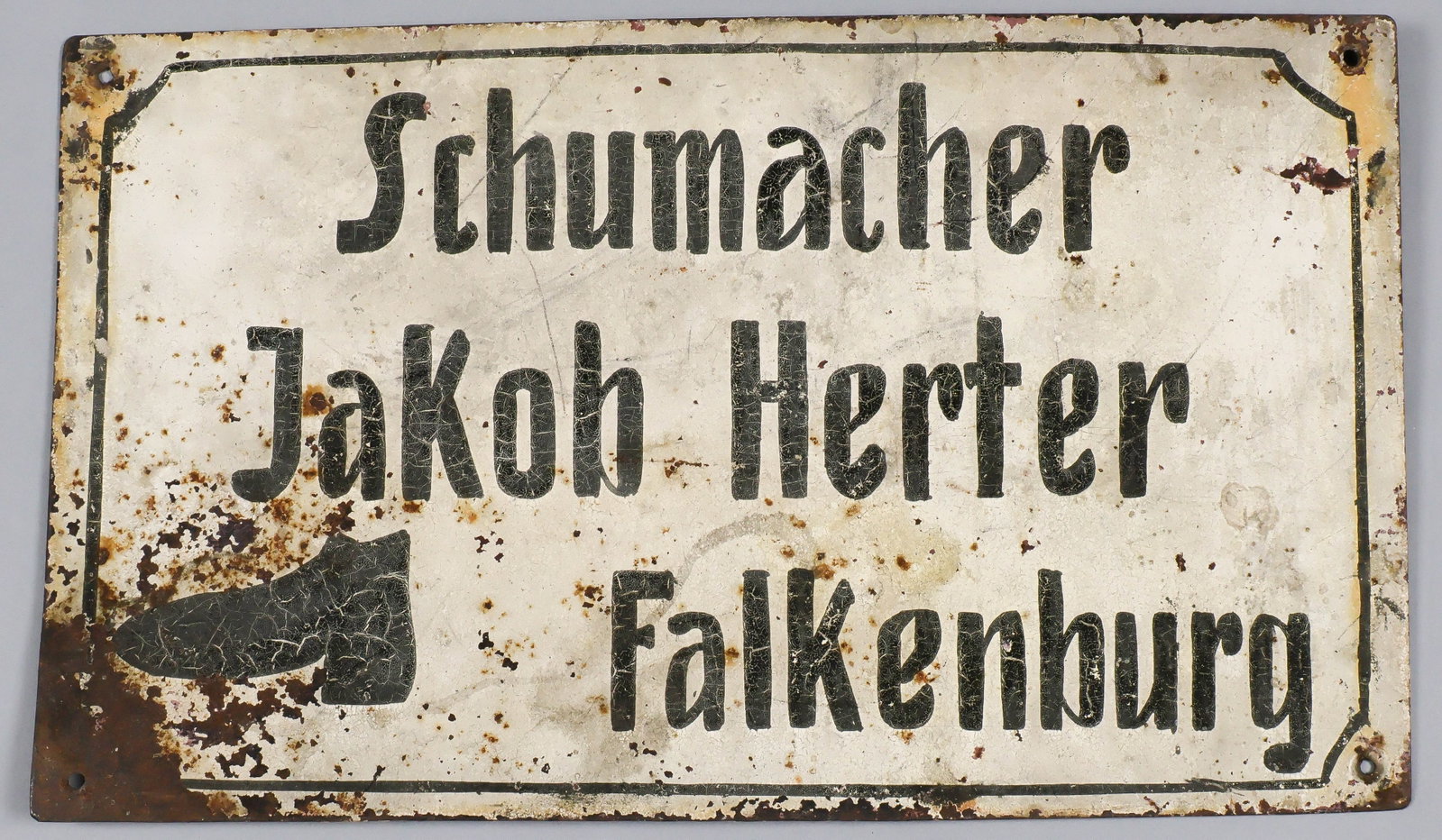 JEWISH SHOEMAKER'S SIGN FROM A FUTURE NAZI STRONGHOLD: Rare iron painted business sign,16.5 x 9.75 in., painted with the text 'Schumacher Jakob Herter Falkenburg' ( 'Shoemaker Jakob Herter', a Jewish surname). 'Falkenburg' was the Germanified name given t