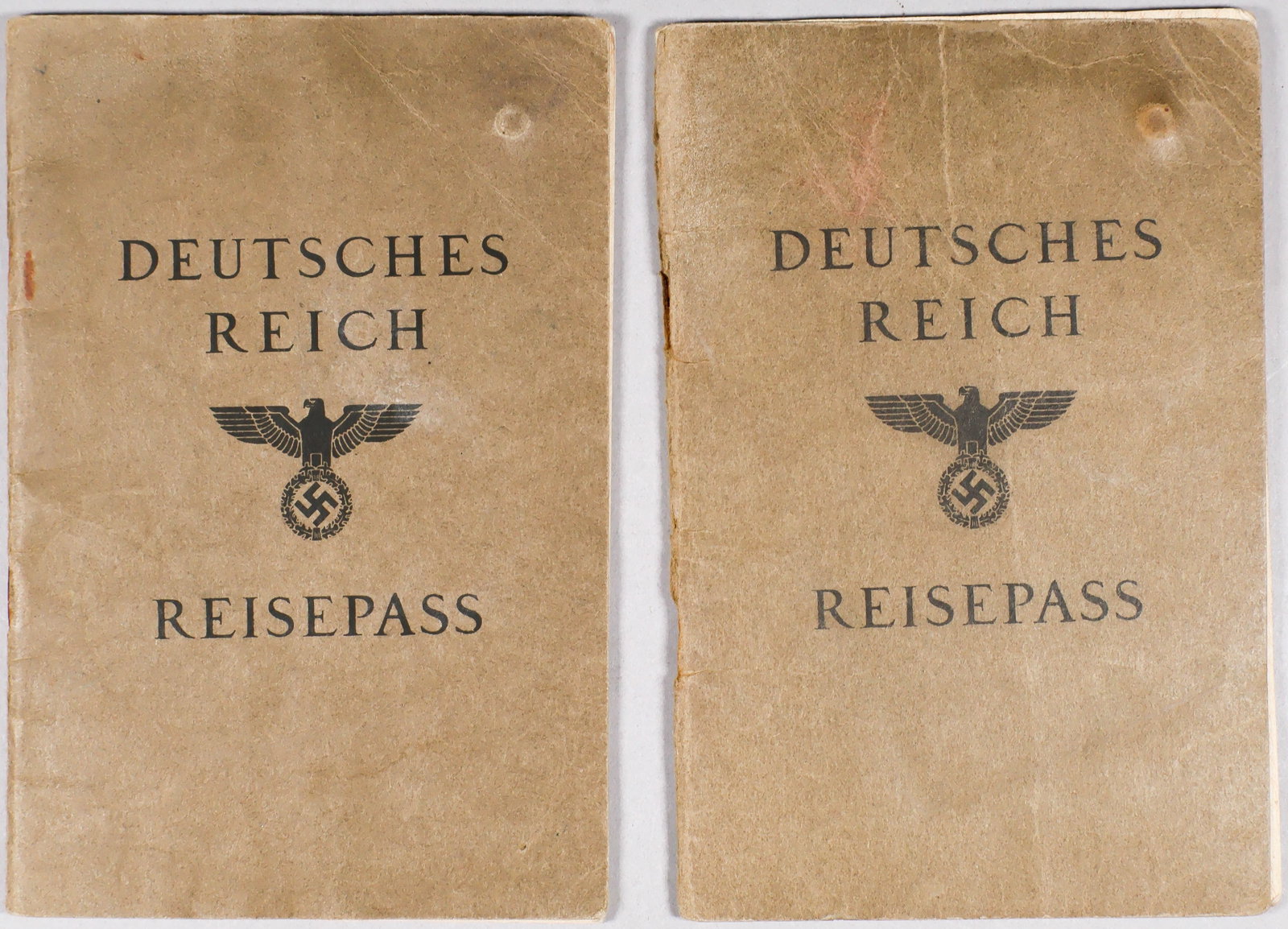 GERMAN PASSPORTS ISSUES TO TWO JEWISH MEN: A pair of ‘Riesepass’: the first, issued to Theodor Israel Moses in Vienna, Apr. 24, 1939. It bears a large red ‘J’ on the first page and signed by Moses on the second page ben