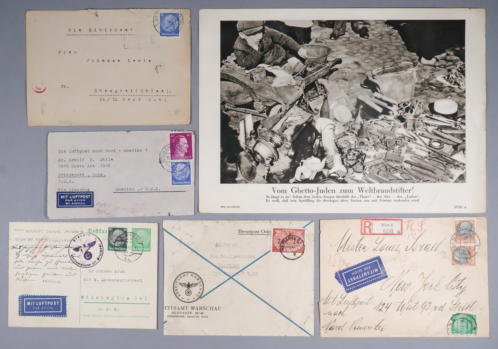 HOLOCAUST (5): A group of Holocaust material, includes: an NSDAP printed photograph showing a young Jewish boy selling various wares on the street, 11 x 8 in. b/w, titled ‘From Ghetto Jews to Arsonists of the 