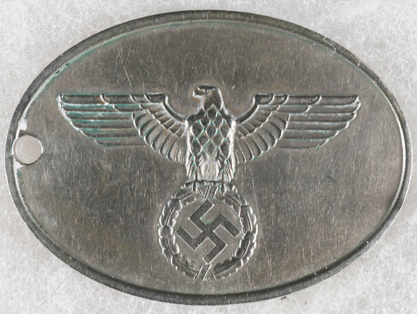 ORIGINAL GESTAPO WARRANT DISC: Very rare and highly desirable warrant disc (Dienstmarken) of the Secret State Police (Geheime Staatspolizei) also known in short as the 'GESTAPO'. This badge, 51 mm. x 39 mm. and weighing 25.31 grams
