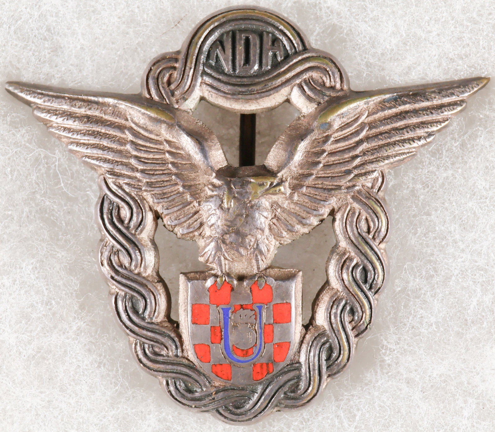 INDEPENDENT STATE OF CROATIA AIR FORCE PILOT’S BADGE, SECOND PATTERN: World War II-era breast badge, approx. 2.5 x 1.75 in., issued to qualified pilots of the ‘Zrakoplovstvo Nezavisne Drzave Hrvatske' (ZNDH) the air force of the Independent State of Croatia. The b