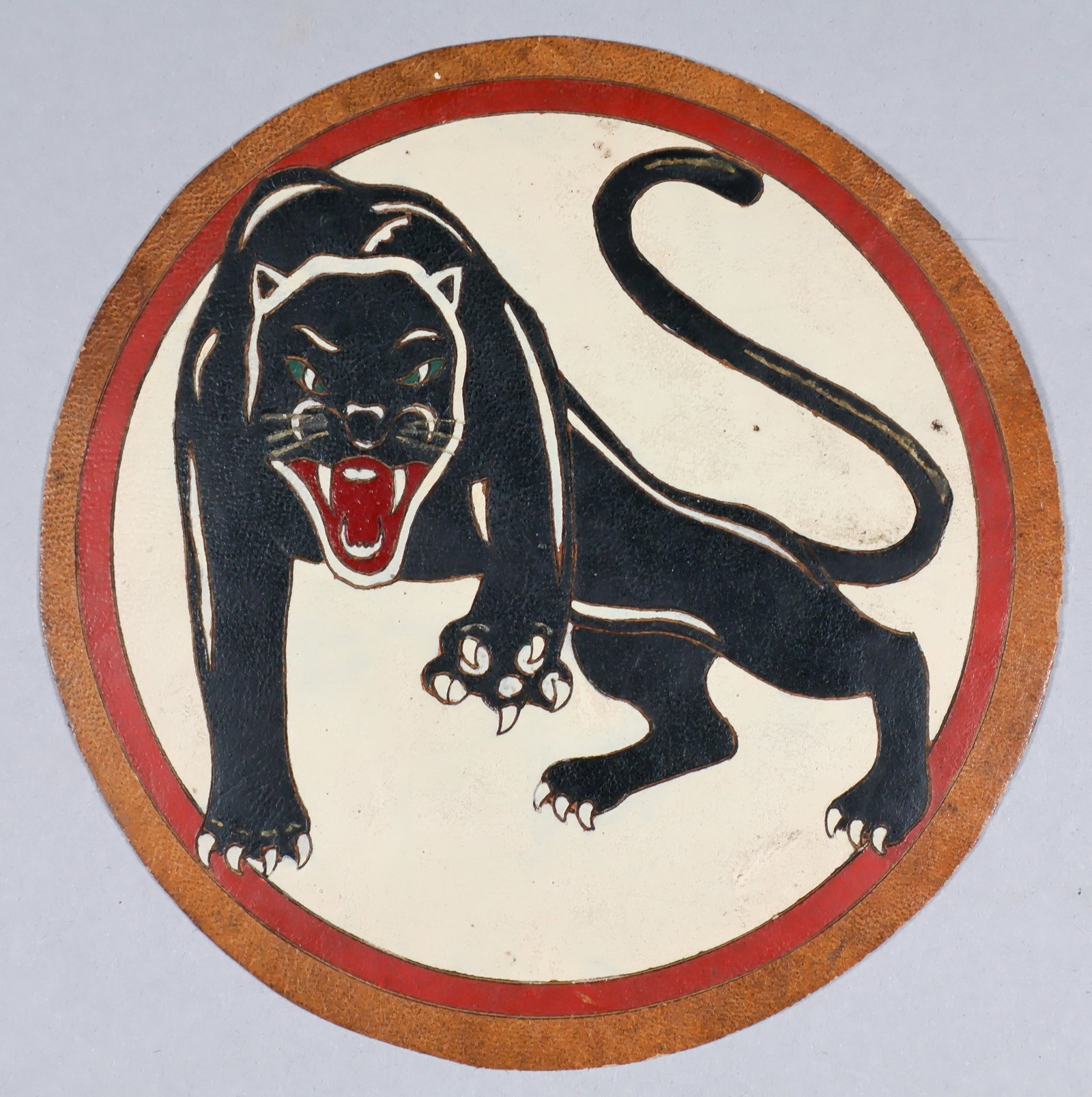 460TH BOMB GROUP LEATHER CHEST PATCH: Rare, completely original 460th Bomb Group leather chest patch, 5.5 in. diameter. On a brown leather backing, the artist first etched the outline and interior details of the design, very exacting in n