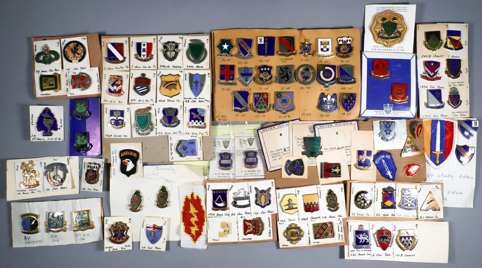 DISTINCT UNIT INSIGNIA (D.U.I.) PINS (+/- 130): Large lot of approx. 130 D.U.I. pins from all types of American military units, many branches of service, all in new condition and unpicked. Sold as a lot.