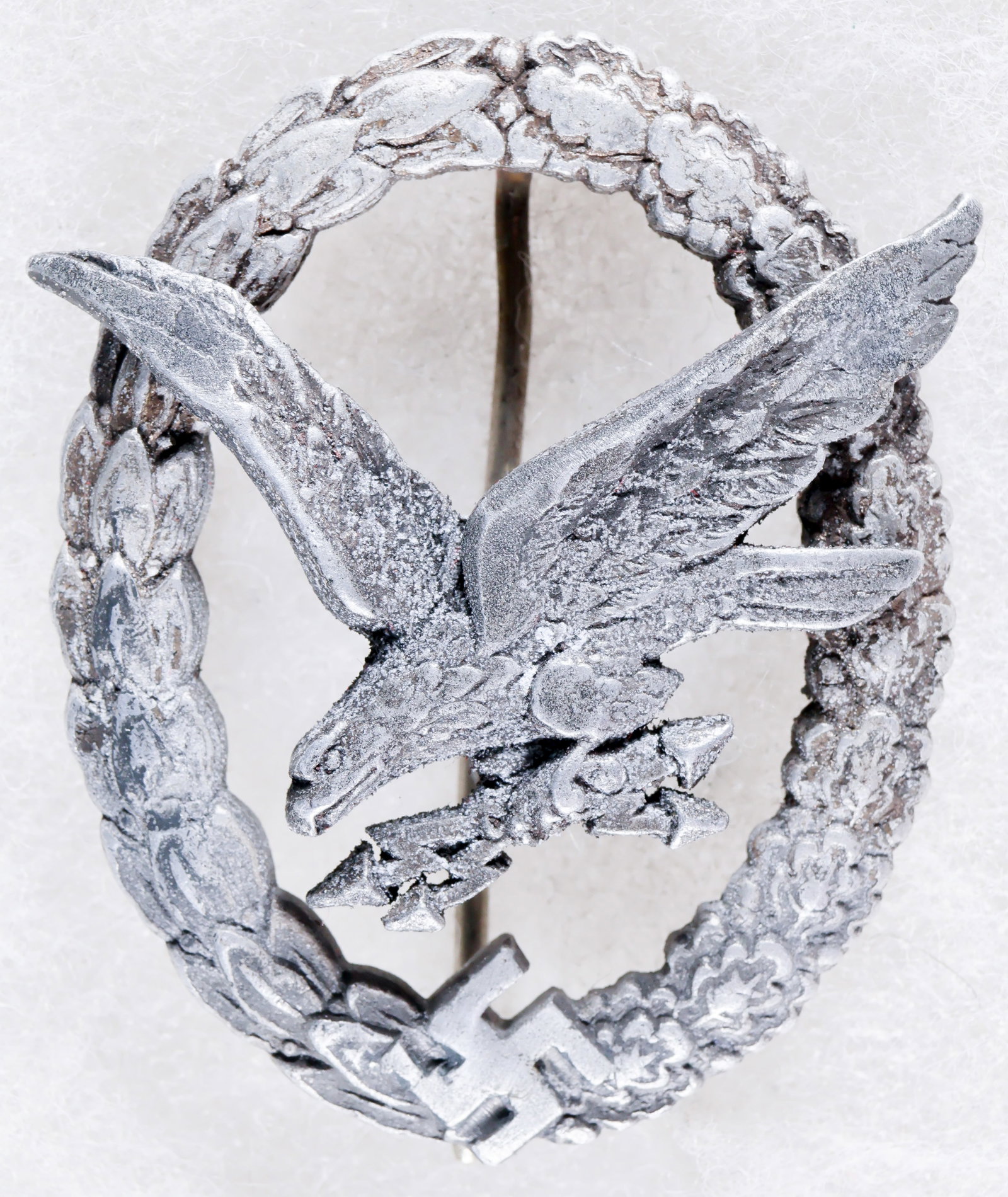 GERMAN RADIO OPERATOR & AIR GUNNER BADGE, IN ALUMINUM: Scarce German Radio Operator & Air Gunner Badge in aluminum, worn a bit, especially so at the eagle's wing tips and upper part of its leg as if the badge had been rubbed along a very rough surface