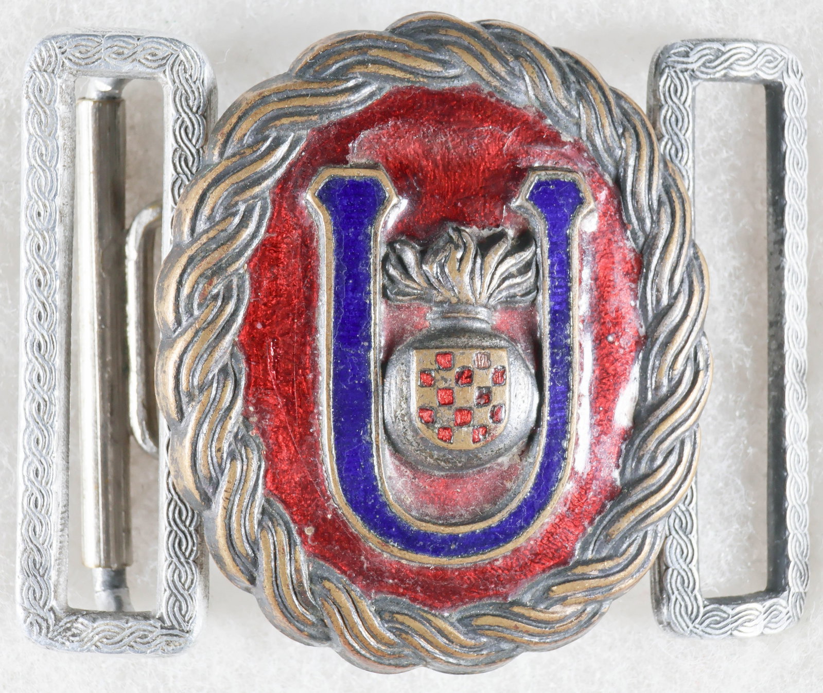 INDEPENDENT STATE OF CROATIA USTASE OFFICER'S BELT BUCKLE: Rare World War II-era belt buckle, 1.75 x 2.25 in., worn by officers of the Ustase, the ruling party of the Independent State of Croatia. The oval buckle is constructed of silvered tombac,