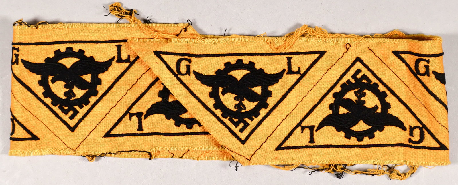 LUFTWAFFE ‘GENERAL LUFTZEUGMEISTER’ INSIGNIA PATCHES (8): An unusual uncut strip of eight scarce Luftwaffe ‘General Luftzeugmeister’ insignia patches, 26 x 3.25 in. Each piece of insignia depicting a Luftwaffe eagle and mobile swastika within a