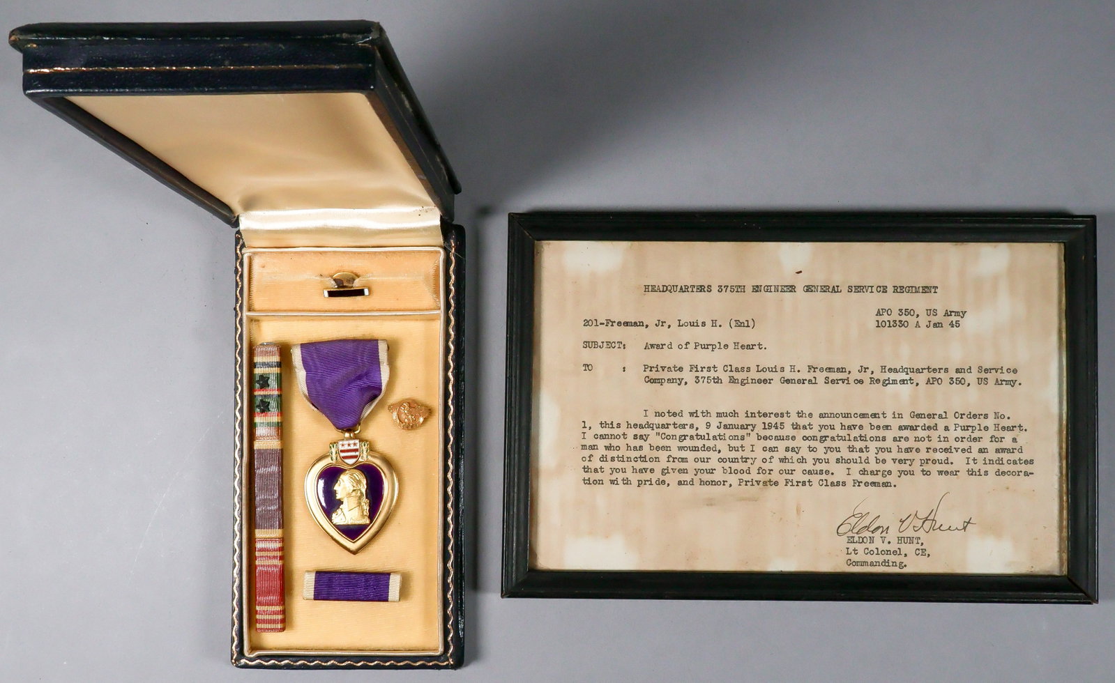 PURPLE HEART AWARDED TO A BLACK SOLDIER: A good grouping of material presented to black American soldier Louis H. Freeman, Jr. of the Headquarters & Service Co., 375th Engineer General Service Regiment. Included is Freeman's Purple Heart wit
