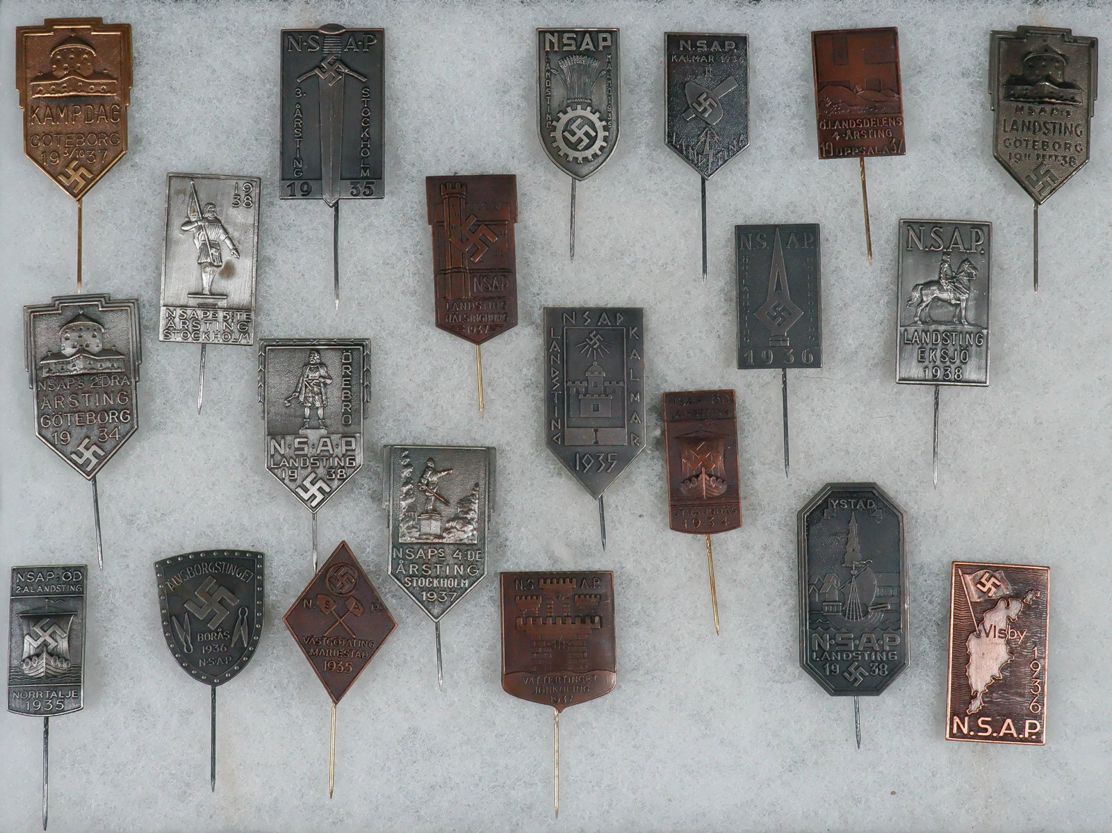 SWEDISH NATIONAL SOCIALIST WORKERS’ PARTY (NSAP) EVENT STICKPINS (21): A fine collection of 21 stickpins commemorating events and gatherings of the Swedish National Socialist Workers’ Party (NSAP), including party national congresses, ‘camp days’, etc. 
