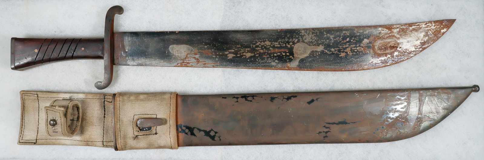 LUFTWAFFE SURVIVAL MACHETE: Luftwaffe-issued survival machete, 16 in. blade, 20.75 in. overall, featuring a brass-framed grip with grooved wood scales secured by two steel flathead screws, and with an ‘S’-shaped