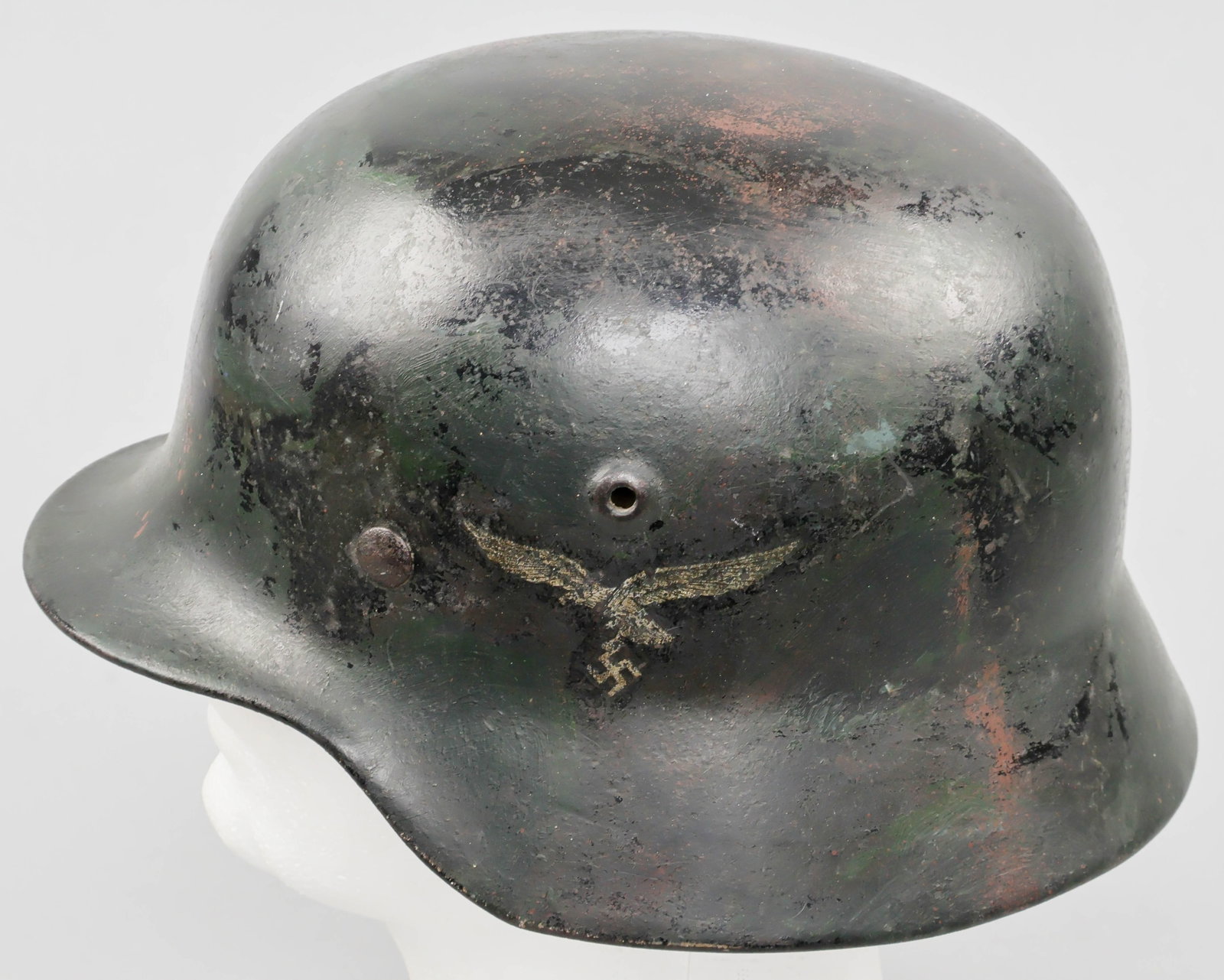 LUFTWAFFE M40 HELMET: A German single-decal M40 combat helmet, featuring a second pattern Luftwaffe eagle decal on the left-hand side. The helmet has been painted overall, around the decal, with glossy black paint or lacqu