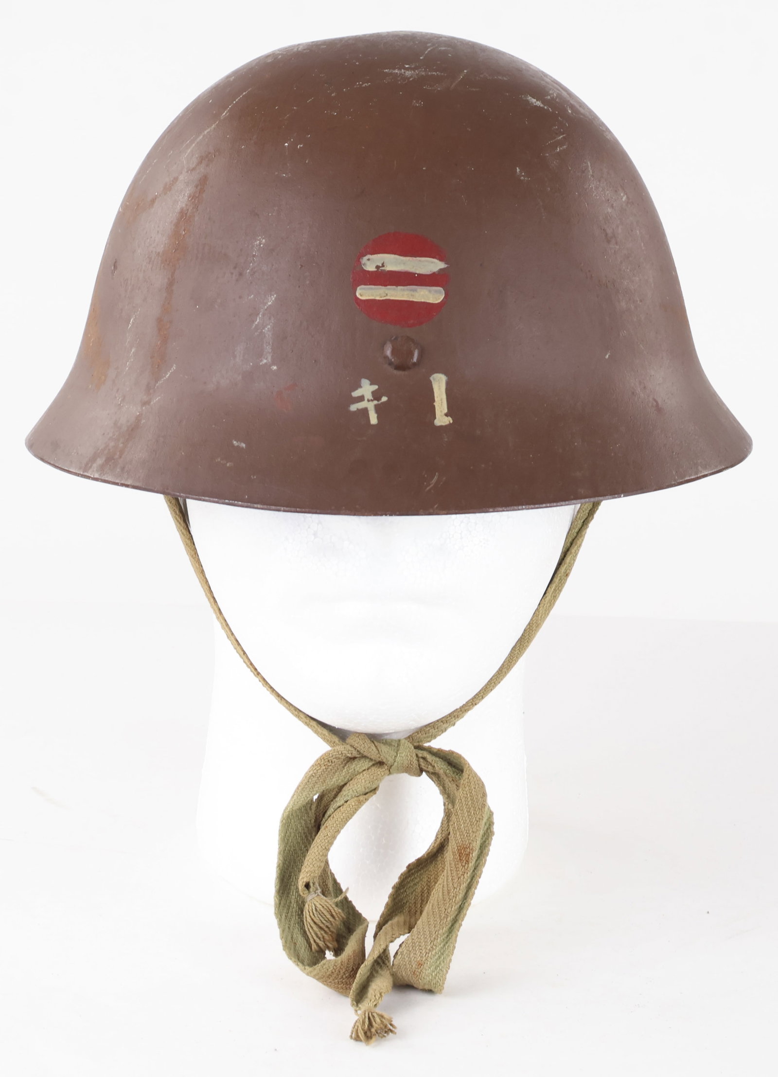 JAPANESE LATE WAR TYPE 90 HELMET WITH INSIGNIA: Japanese Type 90 helmet, believed to be a late war example, green paint to the shell about 80% intact. A painted insignia appears on the rear of the helmet, namely two vertical white bars within a red