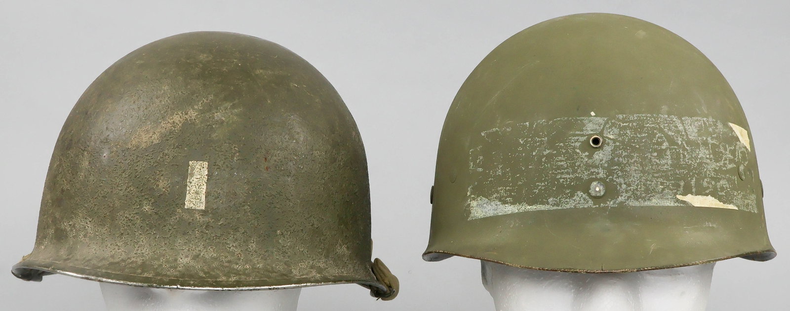 M1 HELMET BY SCHLUETER WITH RANK MARKING: Mid-war U.S. M1 combat helmet, featuring swivel chin strap bills, and a stainless steel rim with seam at the front, indicating manufacture prior to October of 1944. The helmet is finished inside and o