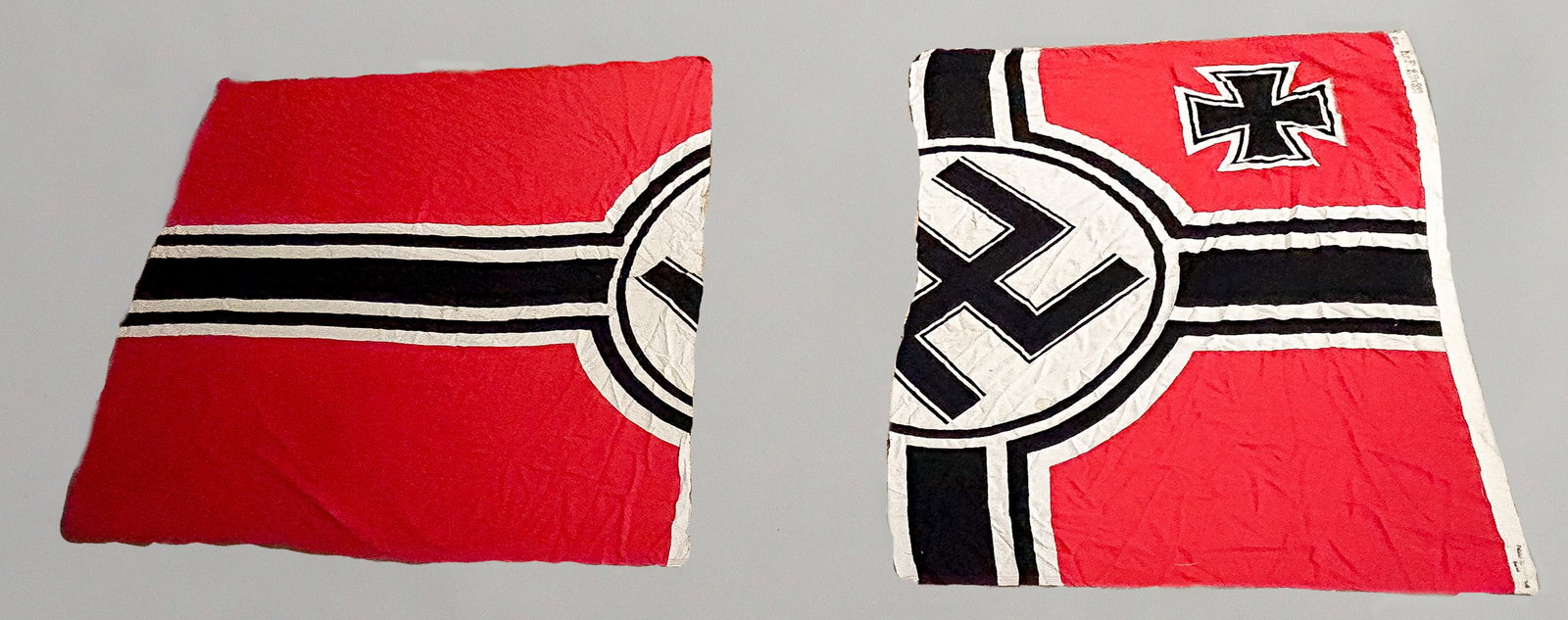 GERMAN KRIEGSFLAGGE: This large iconic German battle flag (Kriegflagge) was originally 131 in. x 78 in. overall, but now trimmed. The two-sided flag with 'Eagle M' marking at the top of the hoist, is constructed of